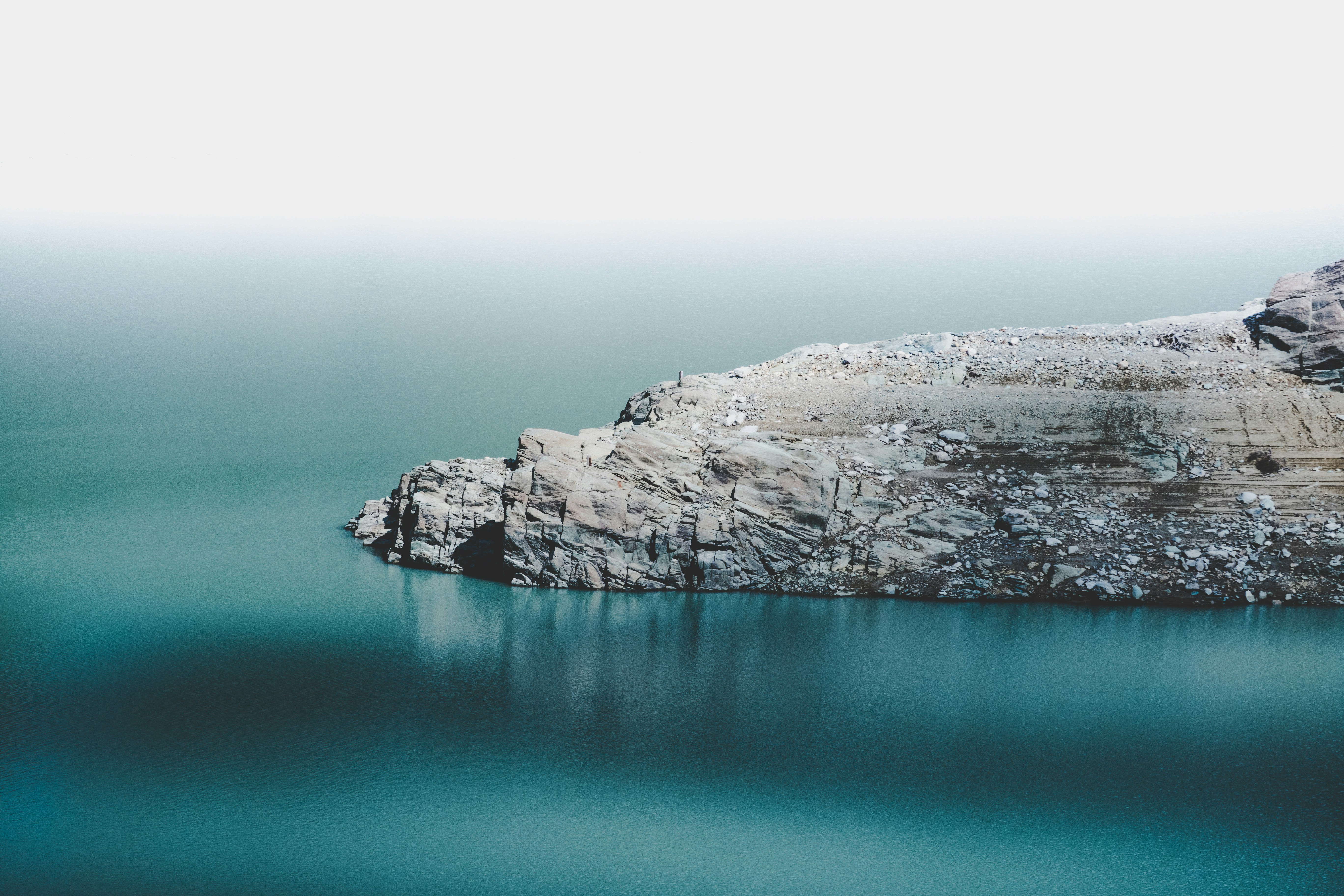 Rocky Shore by Calm Blue Water