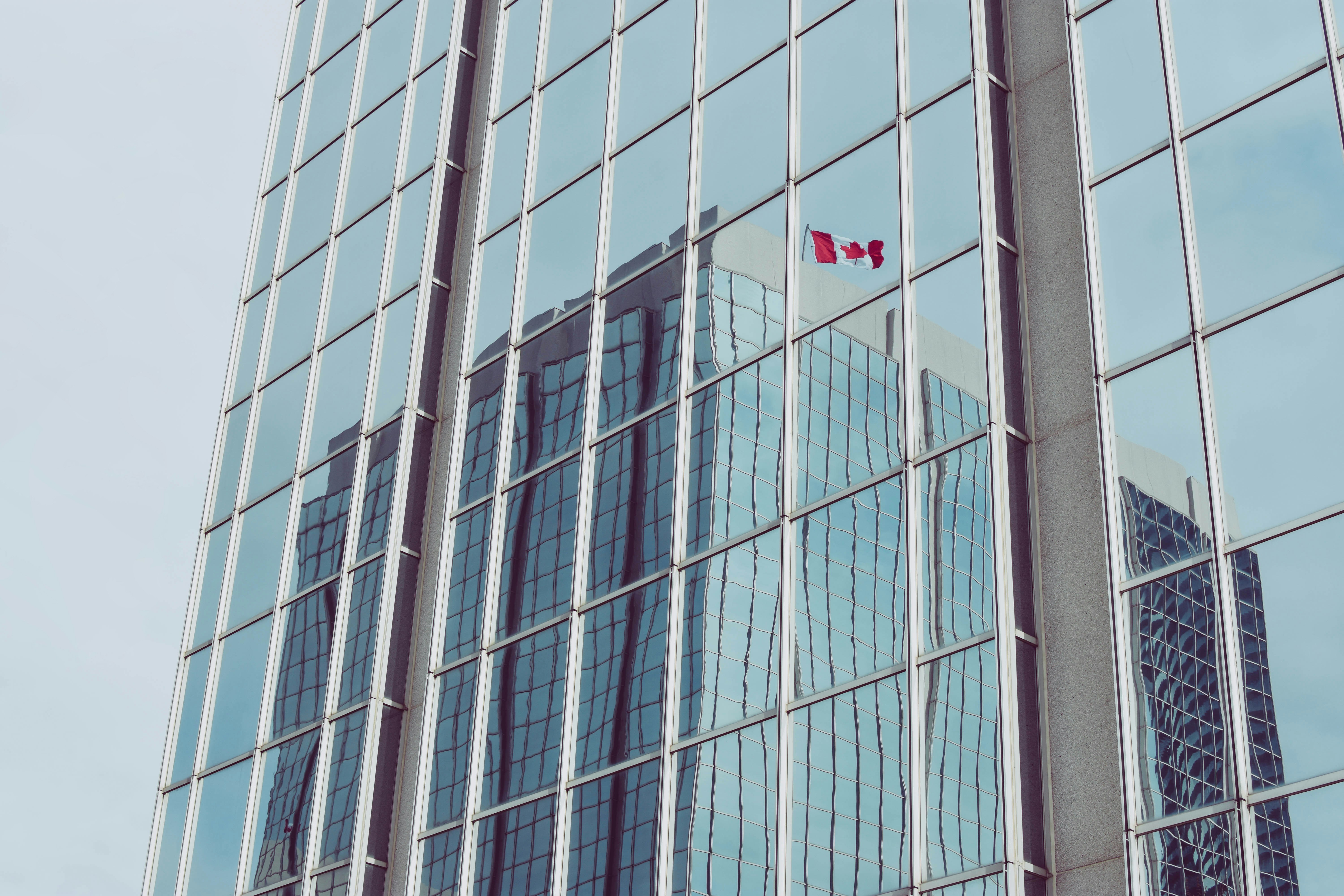 Glass Skyscraper Reflecting Canadian Flag