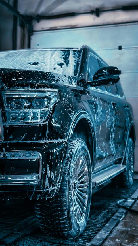 Black SUV Being Washed In Garage