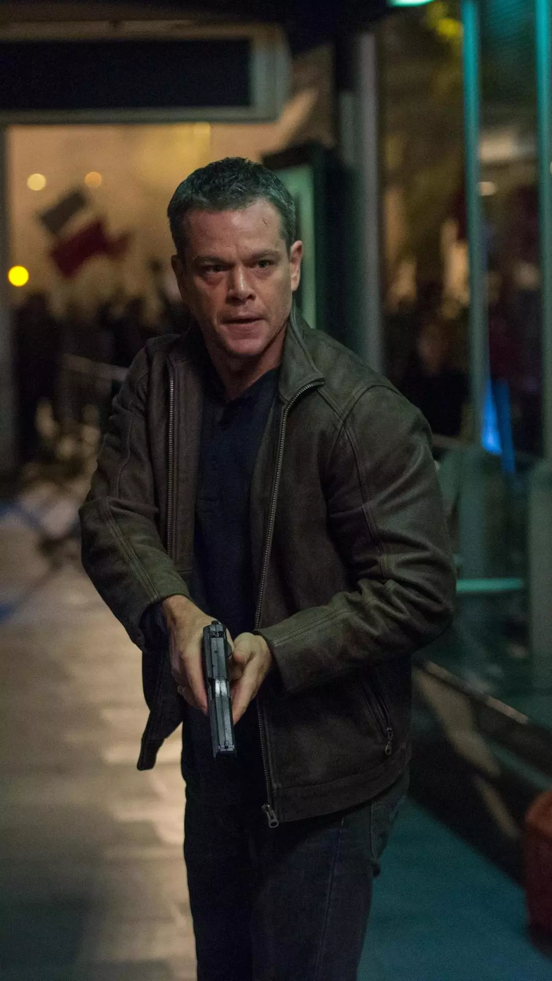 Jason Bourne Holding a Pistol