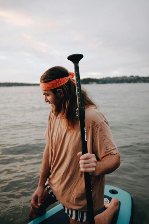 Man Paddleboarding on Lake