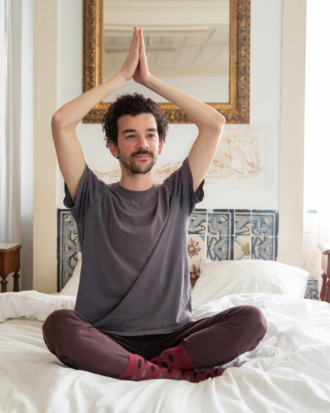 Man Doing Yoga on Bed