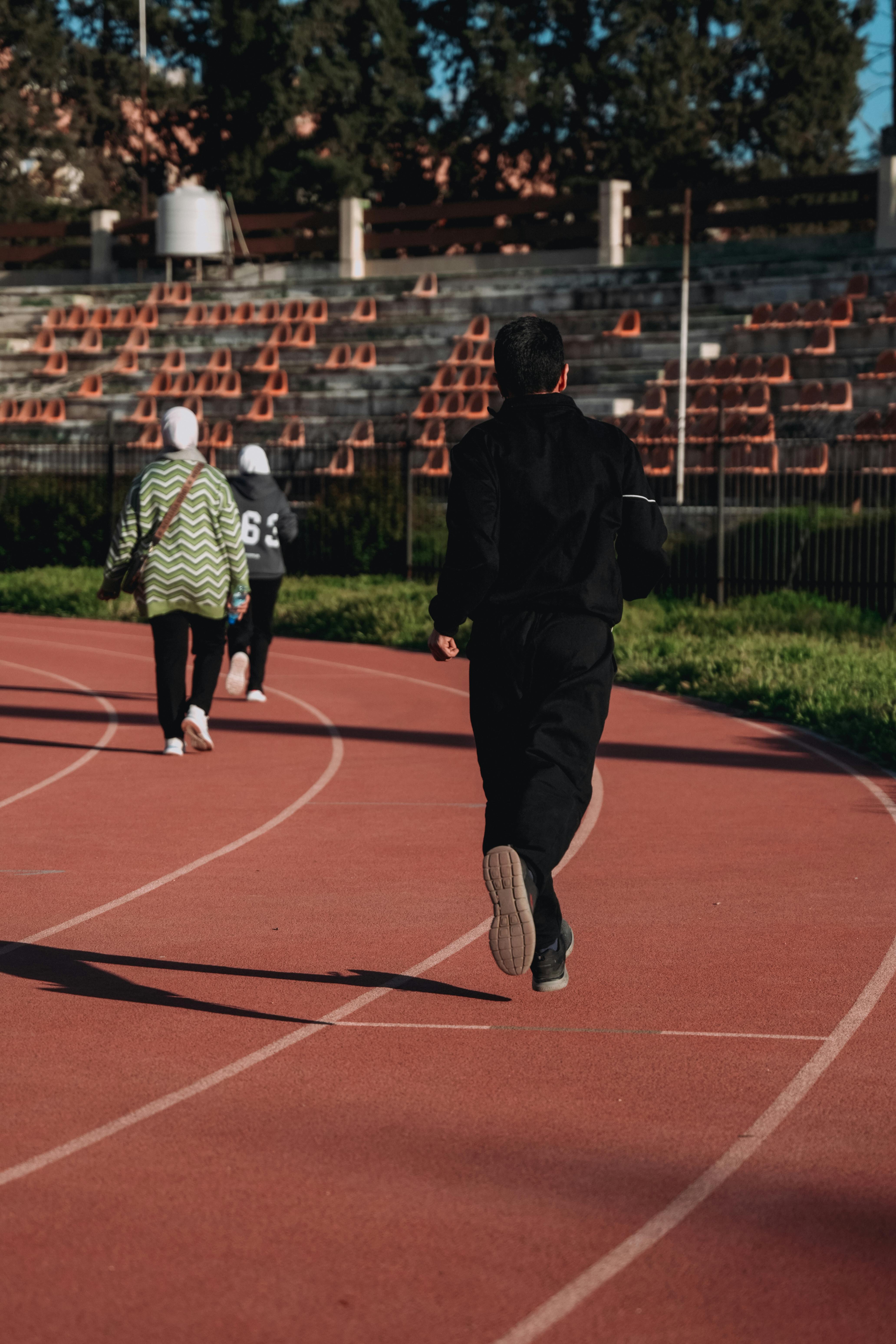 People Exercising on Outdoor Running Track