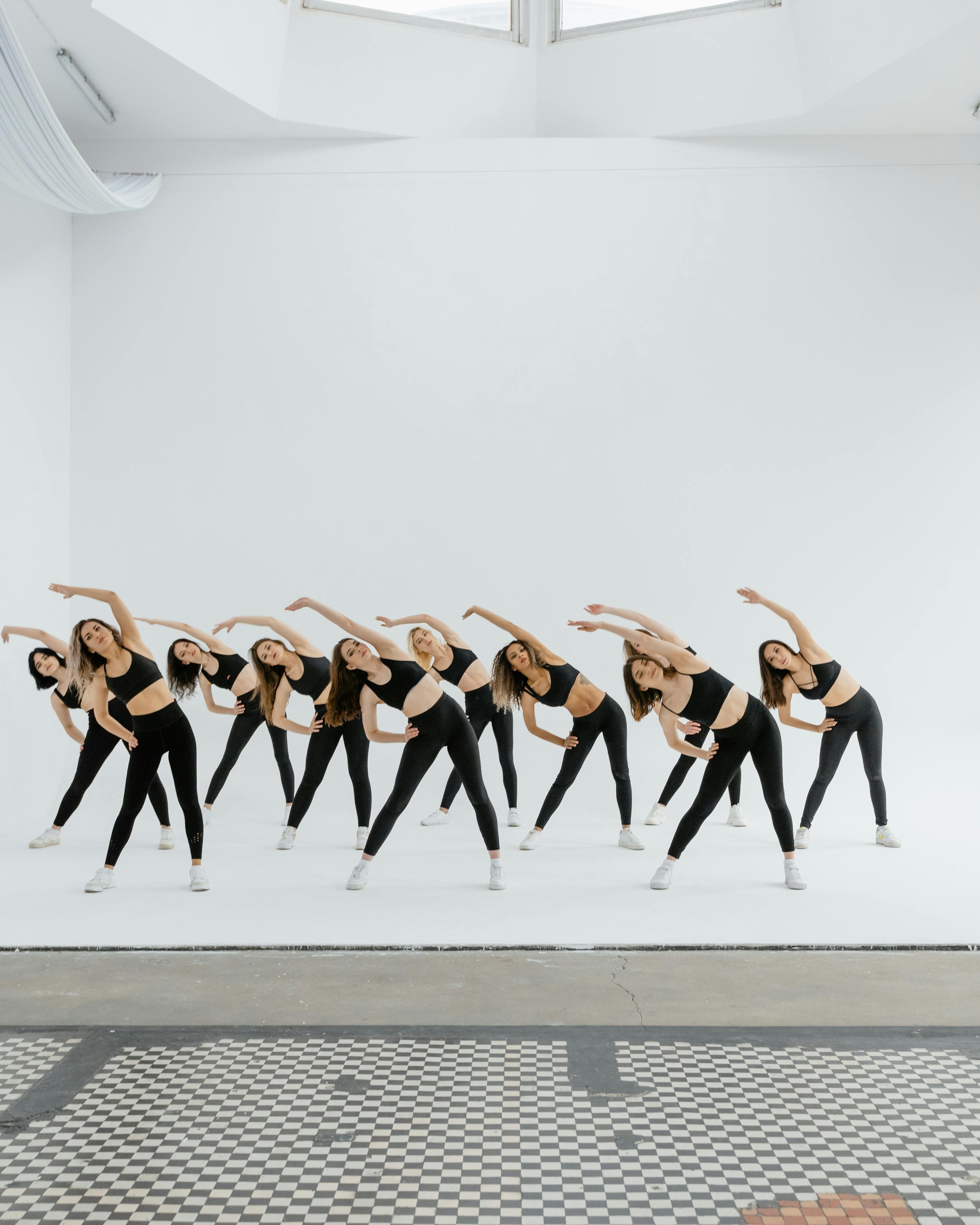 Group of Women Doing Synchronized Stretching