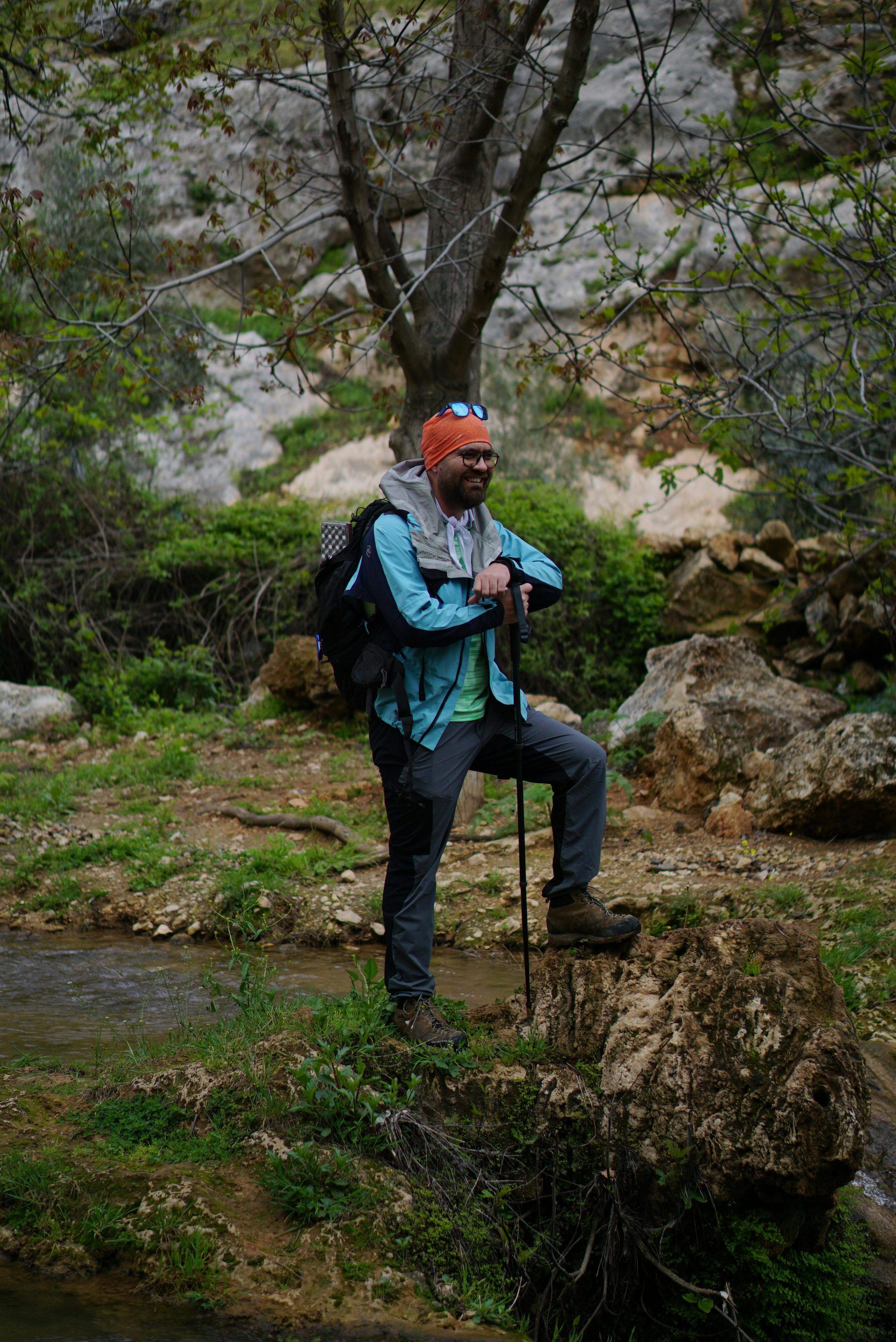 Hiker Resting Beside Mountain Stream