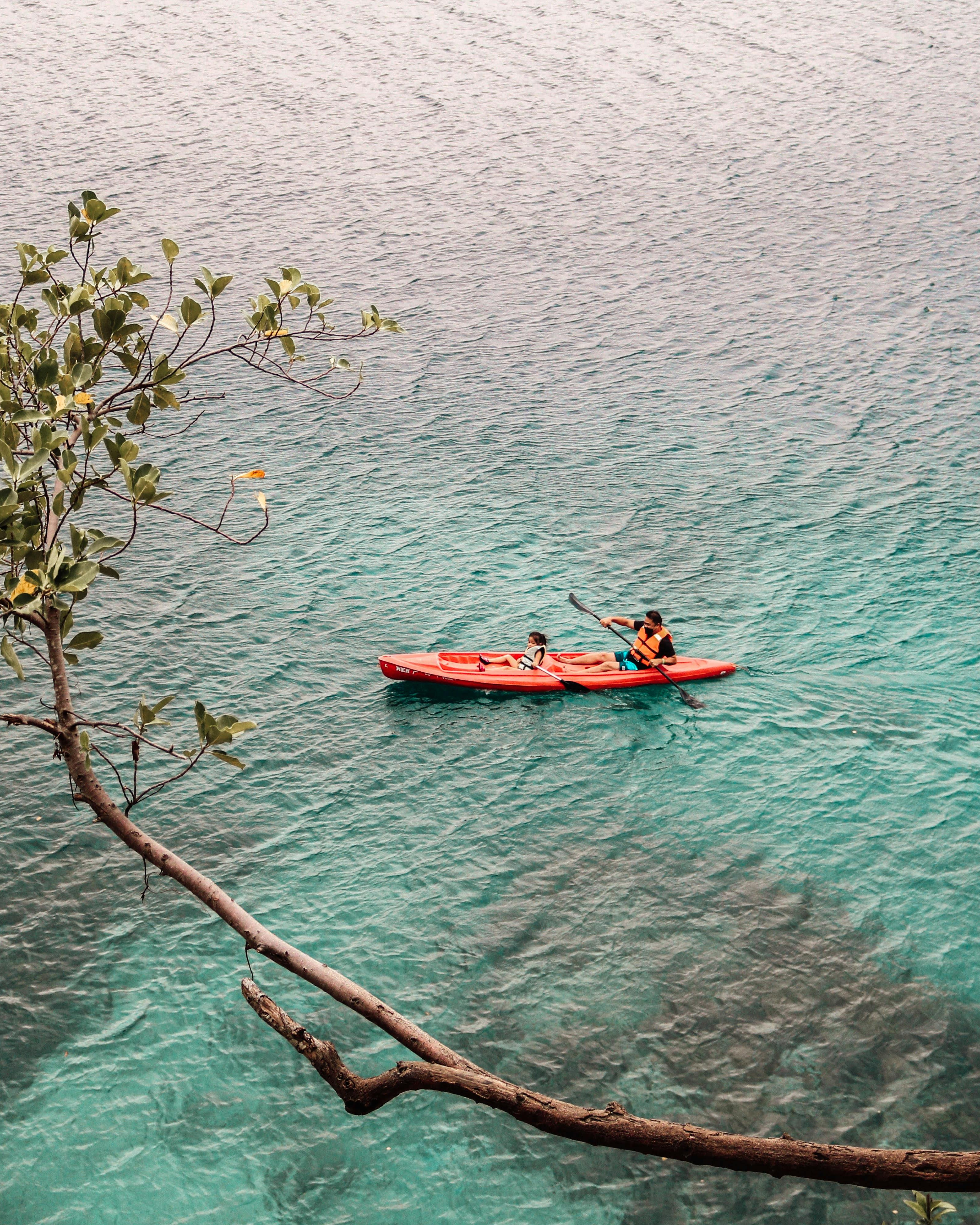 Two People Kayaking on Clear Turquoise Water