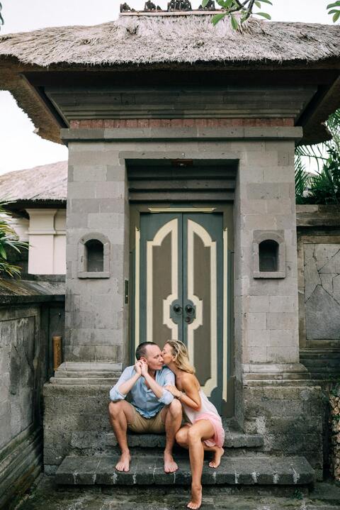 Couple Kissing In Front Of Traditional Gate