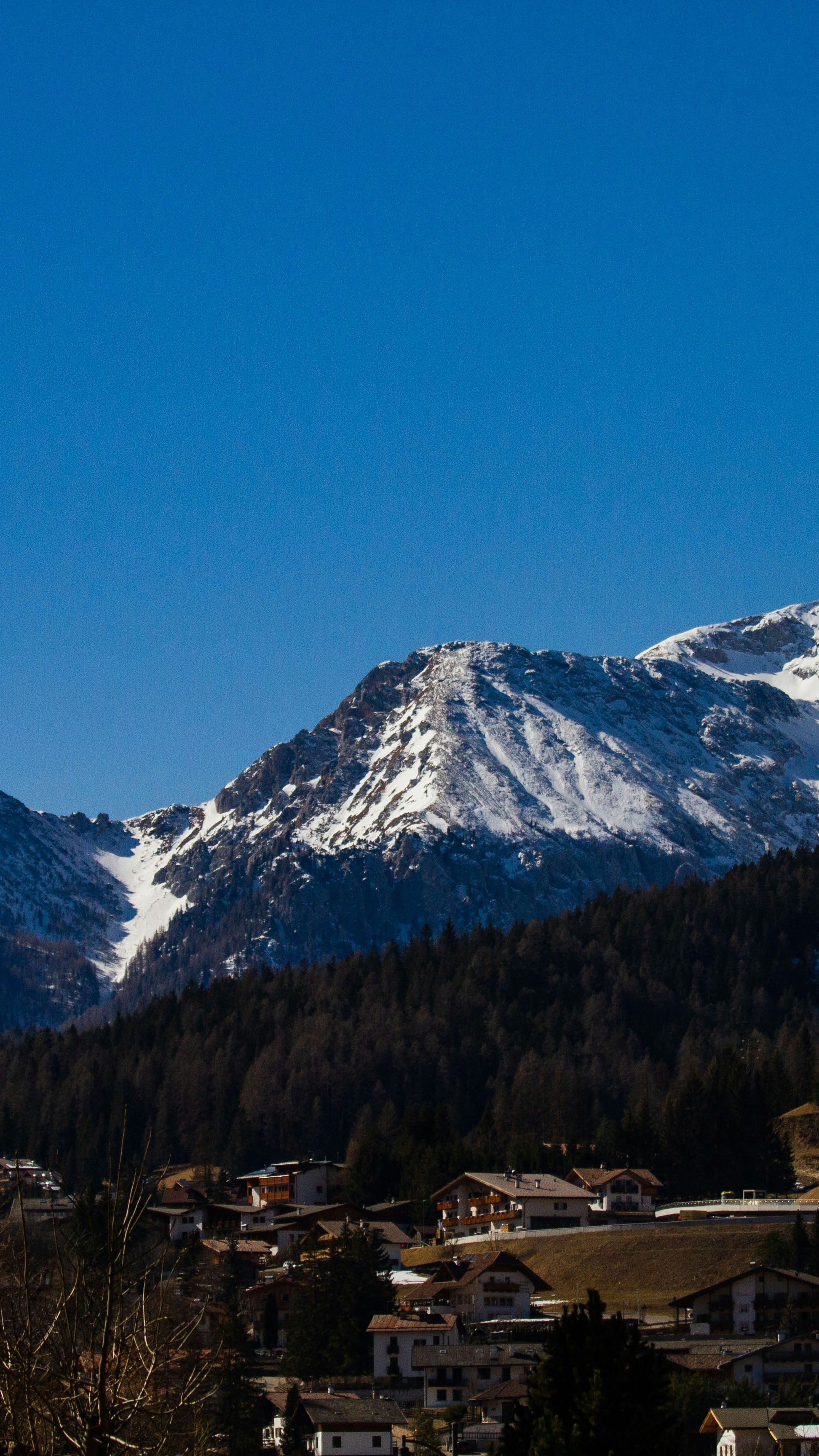 Alpine Village Under Snow-capped Mountains