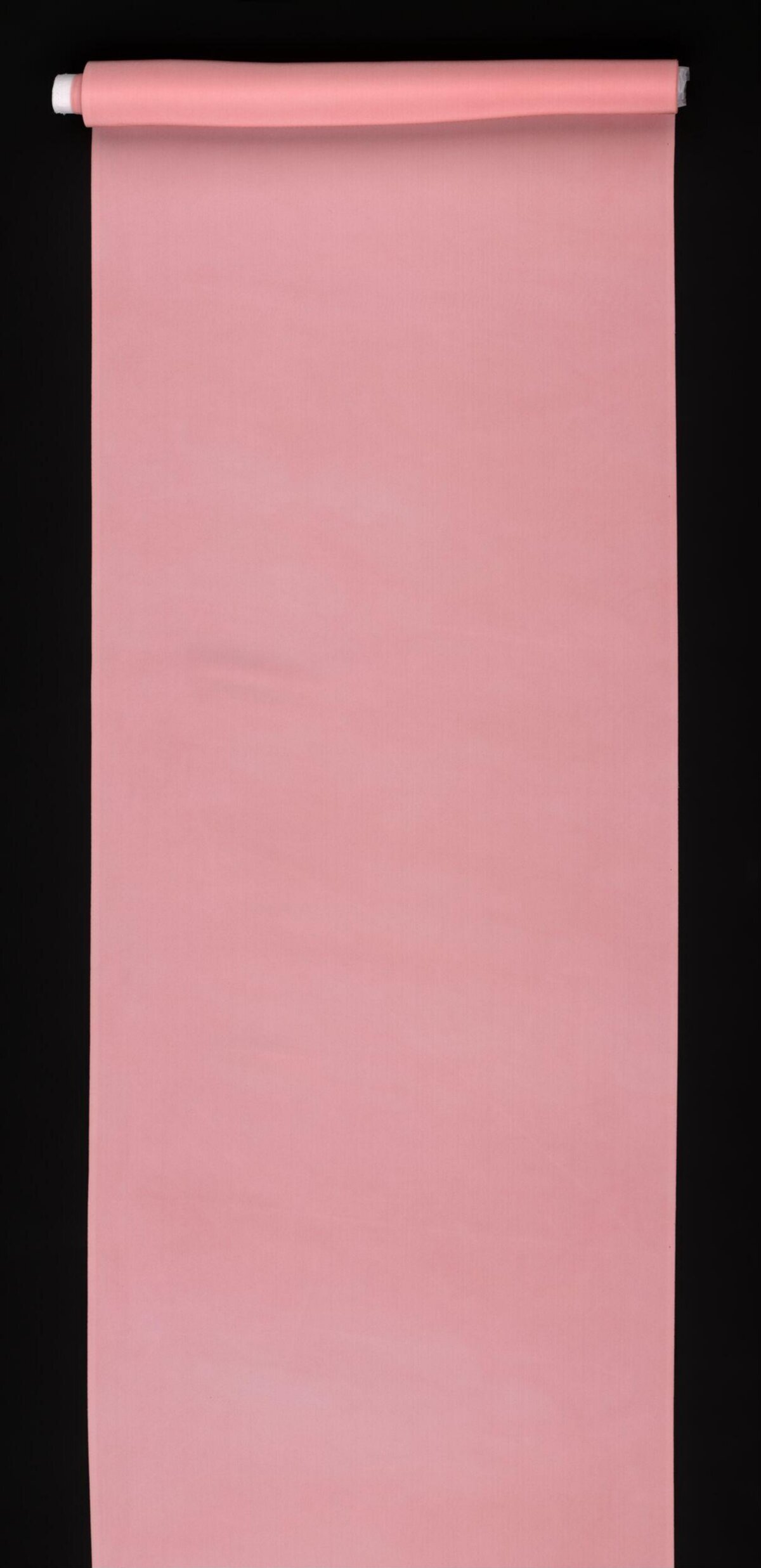 Rolled Pink Fabric on Black Background