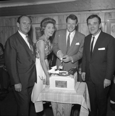 Four People Cutting Celebration Cake