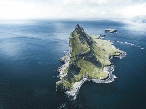 Steep Grassy Island in Open Sea