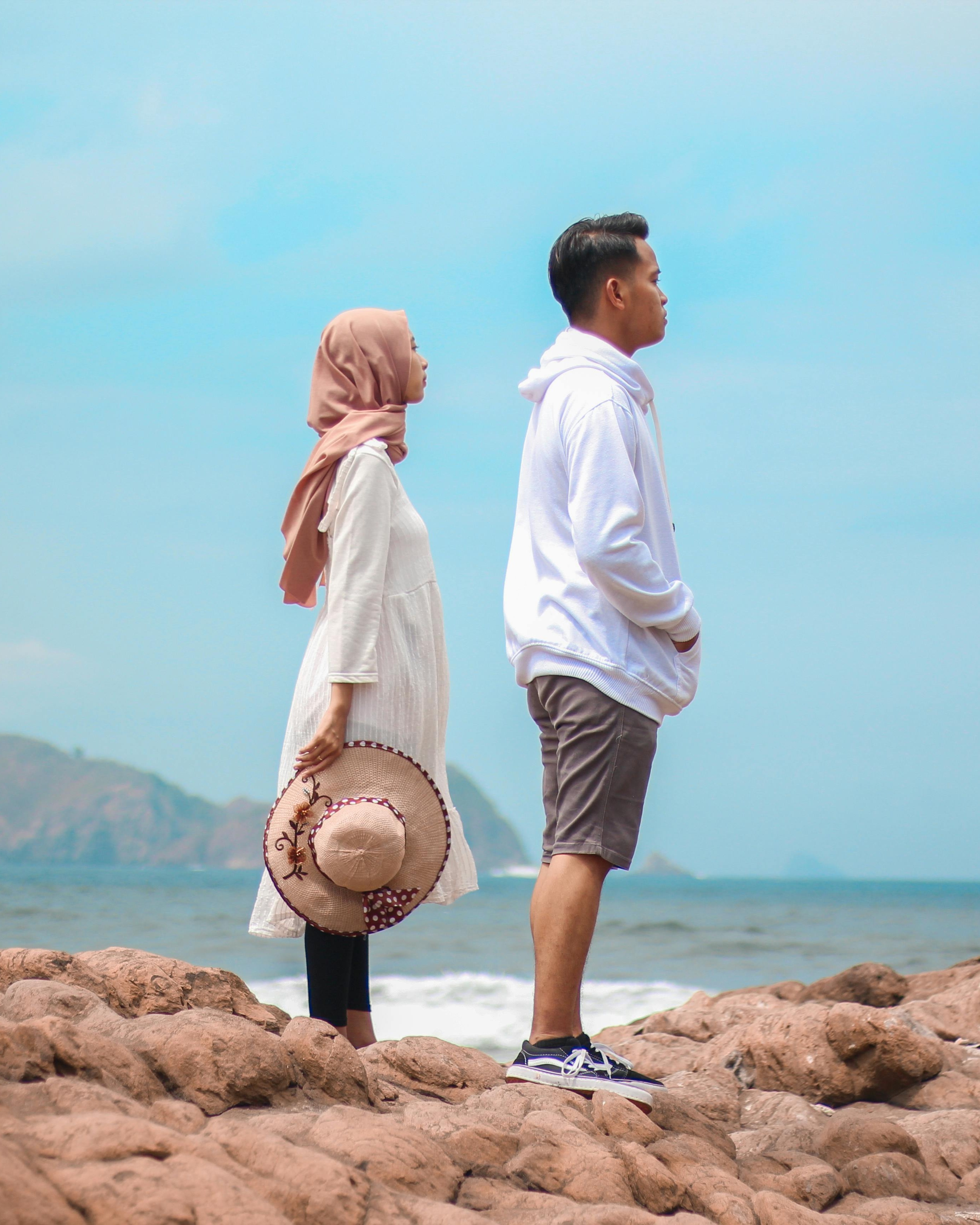 Couple Standing on Rocky Seaside