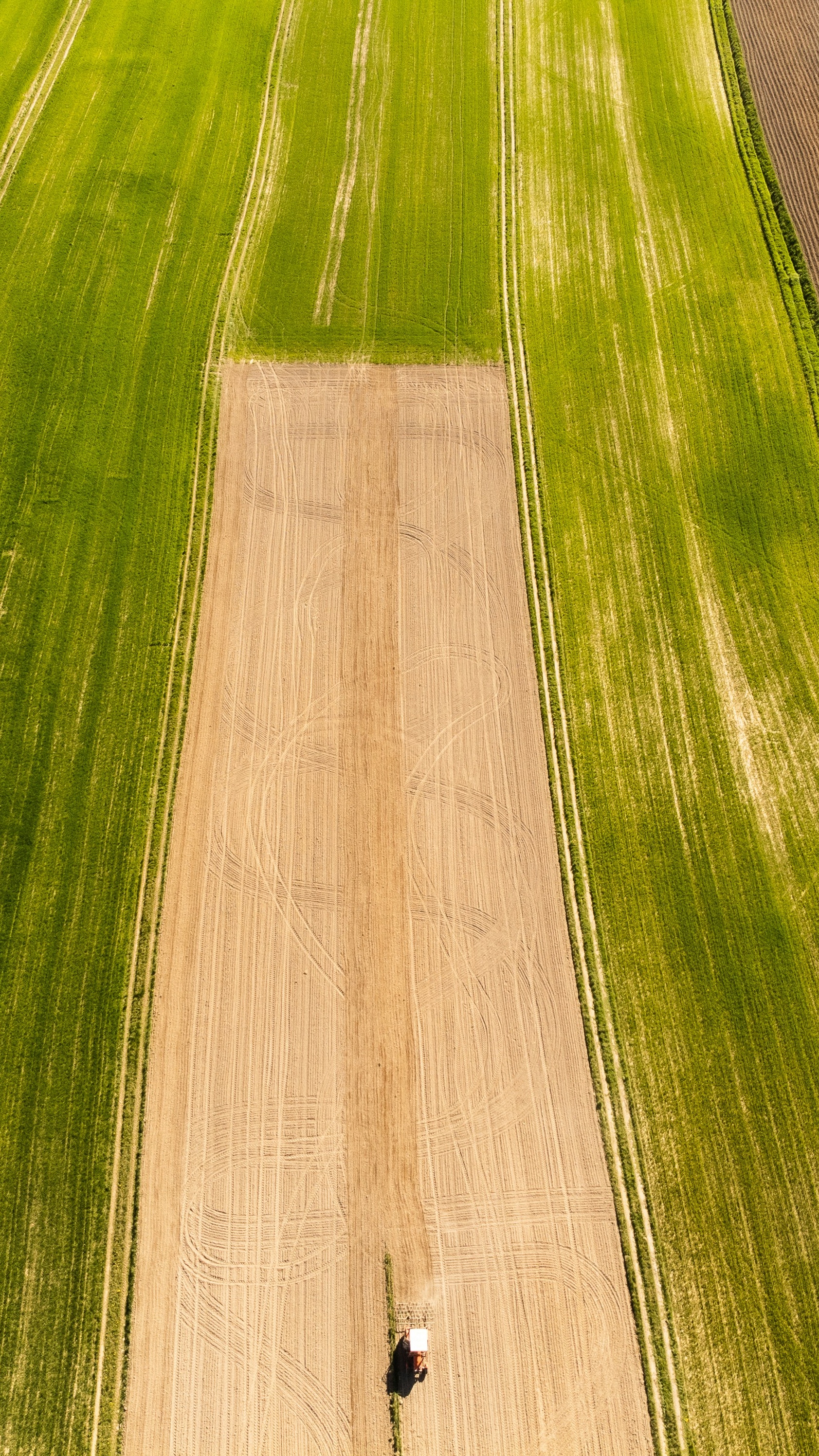 Aerial View of Tractor Working Farm Field
