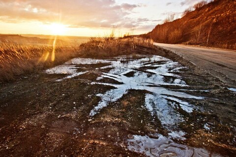 Sunset Over Roadside Frozen Puddle