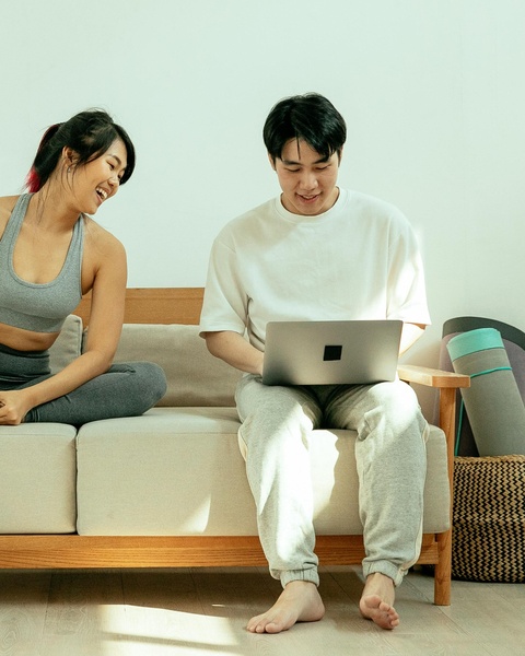 Young Couple Viewing Laptop on Sofa
