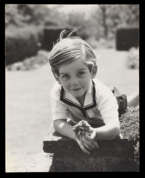 Young Boy Holding Flower Outdoors