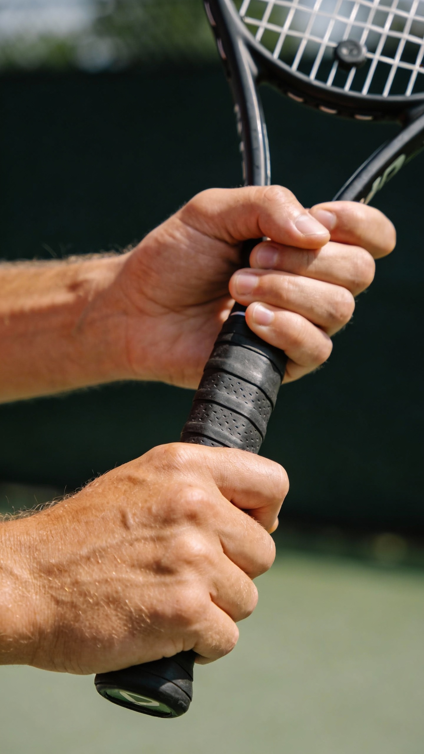 Two Hands Grip A Tennis Racket
