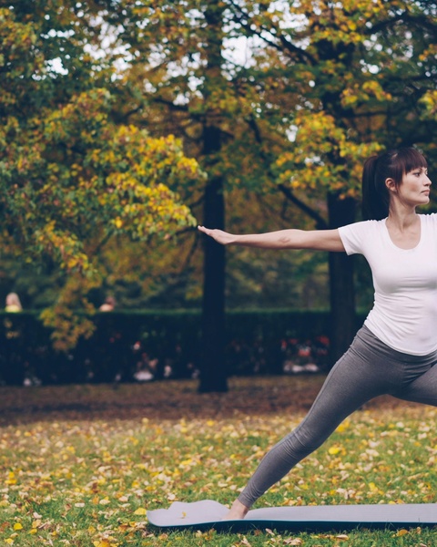 Woman Doing Yoga in Autumn Park