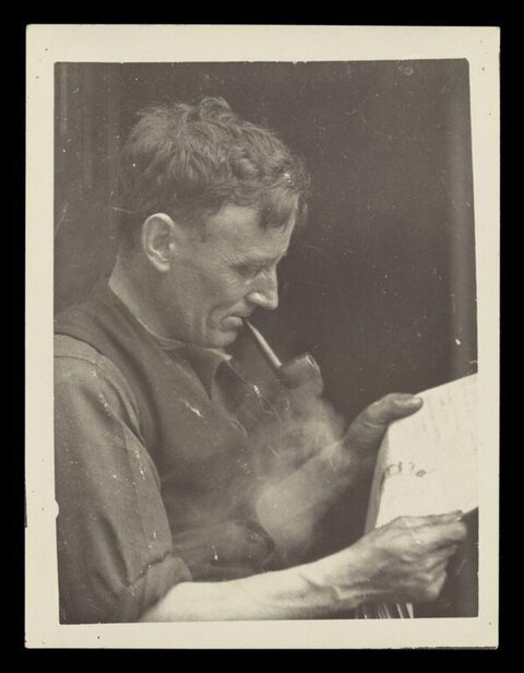 Man Smoking Pipe While Reading