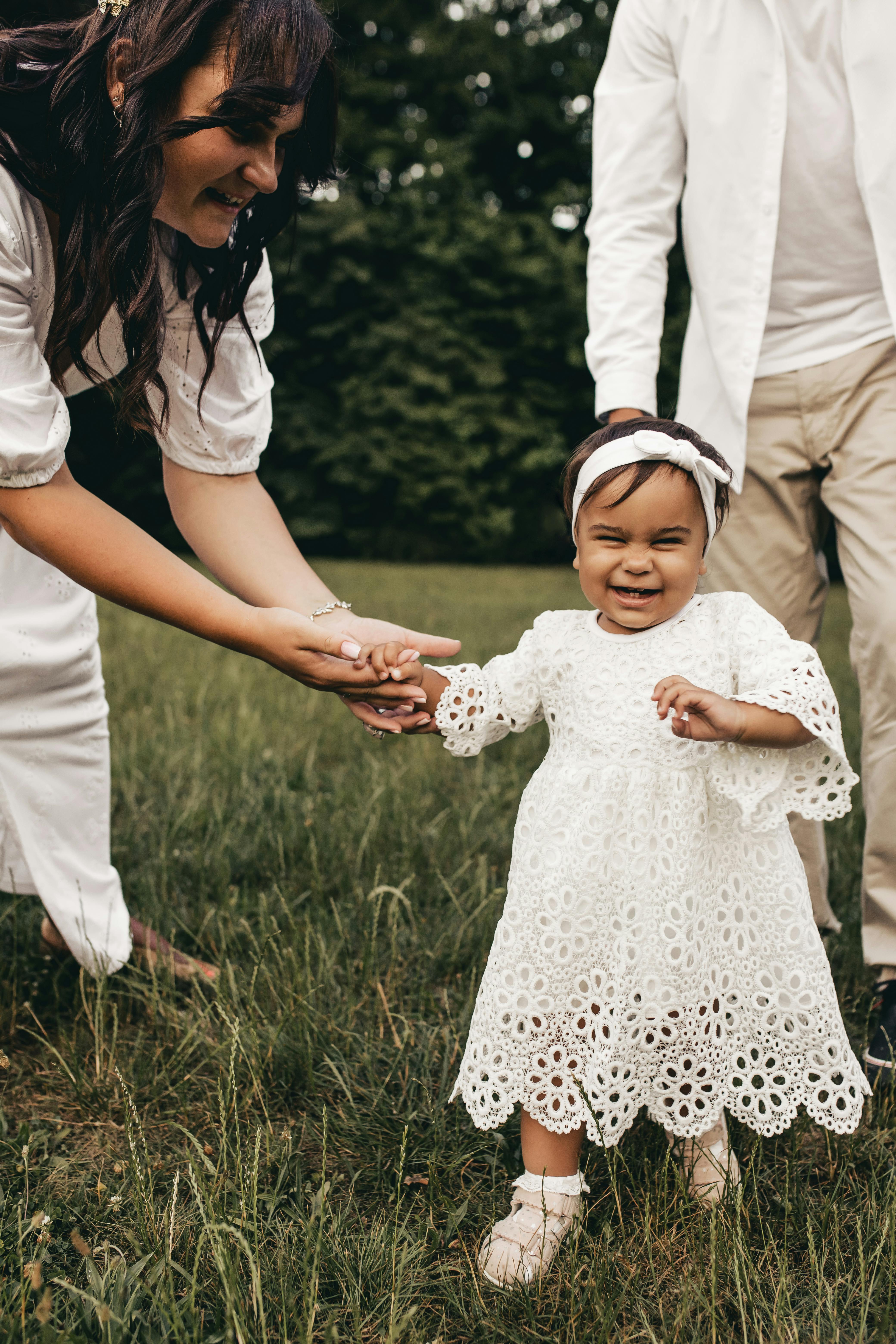Toddler Learning To Walk With Parents