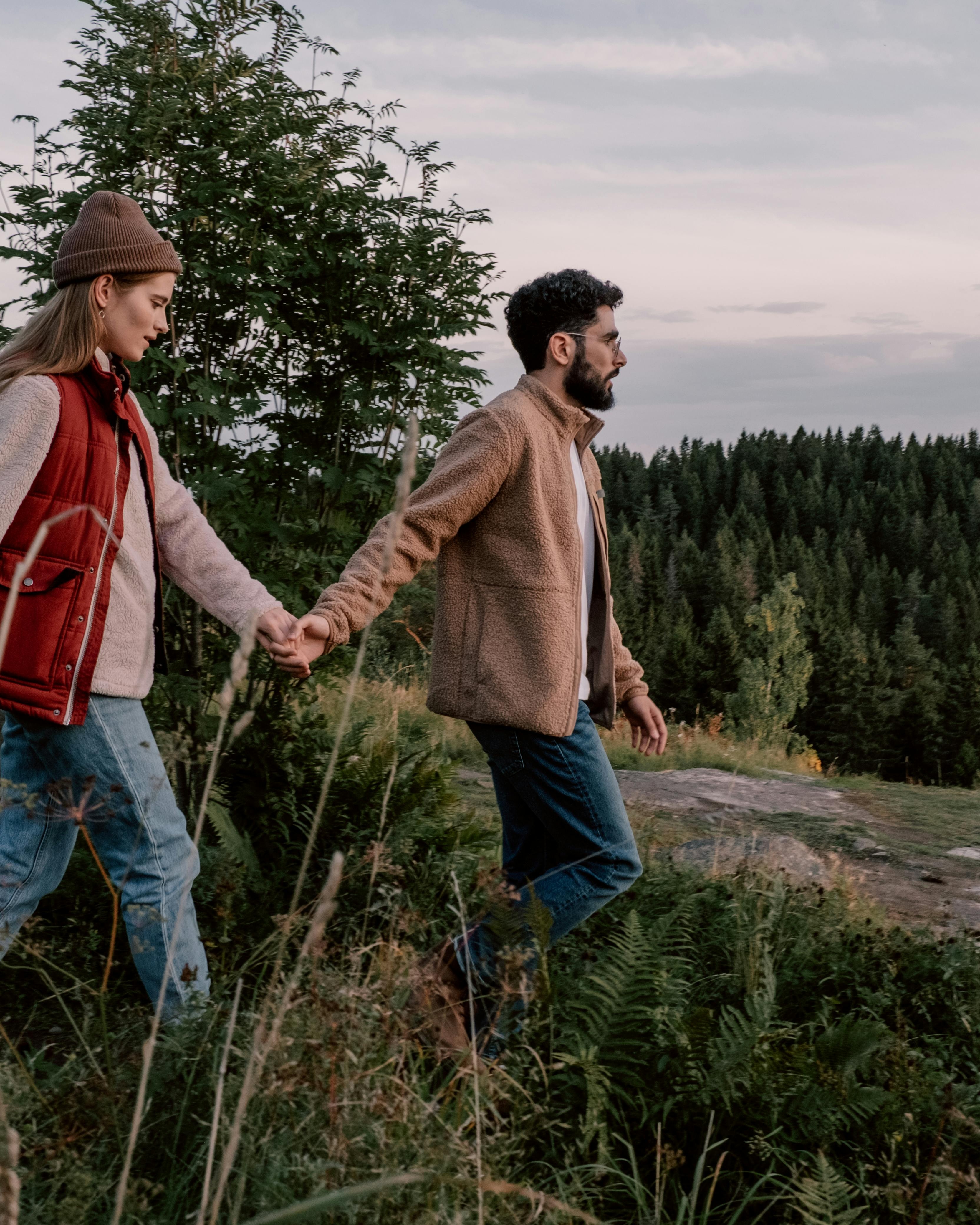 Couple Holding Hands Hiking in Nature