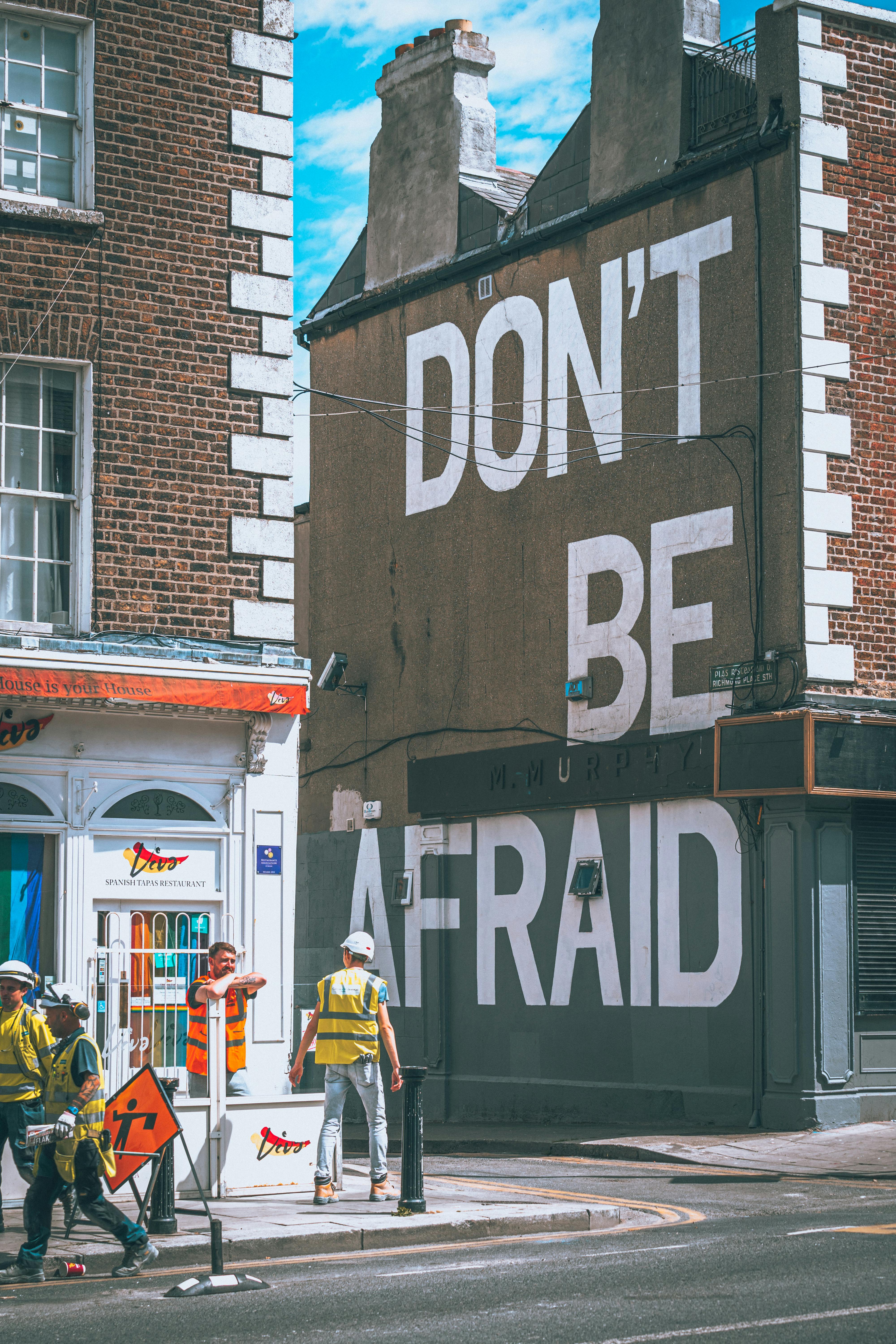 Don't Be Afraid Mural on City Street Corner