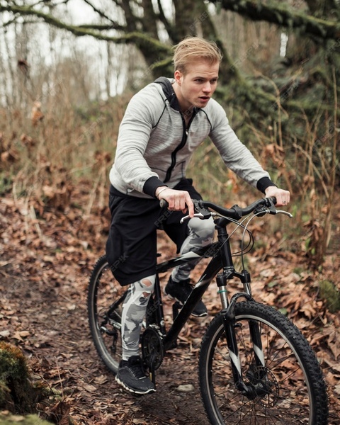 Man Mountain Biking on Forest Trail