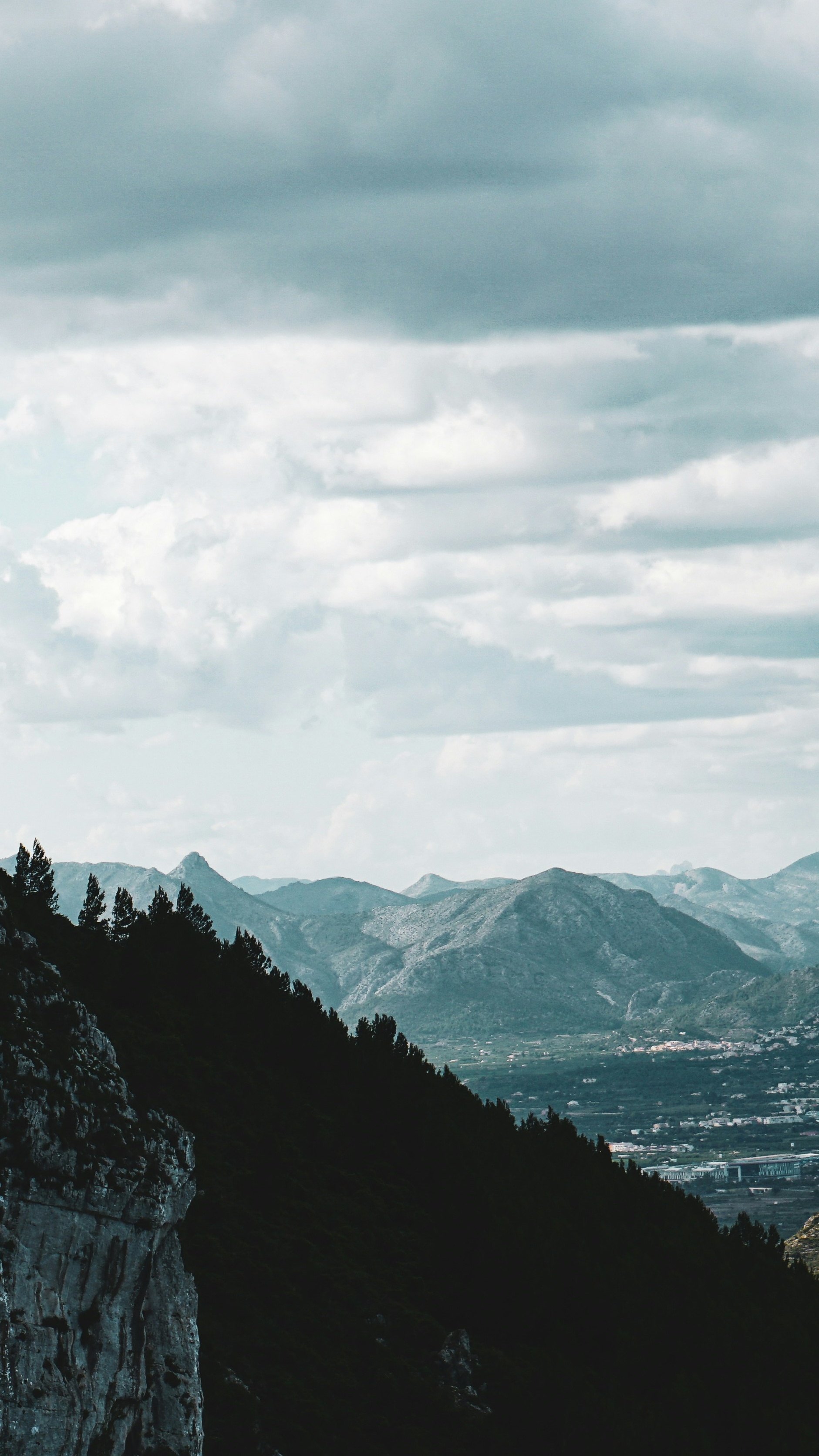 Cloudy Mountain Landscape from Forested Ridge