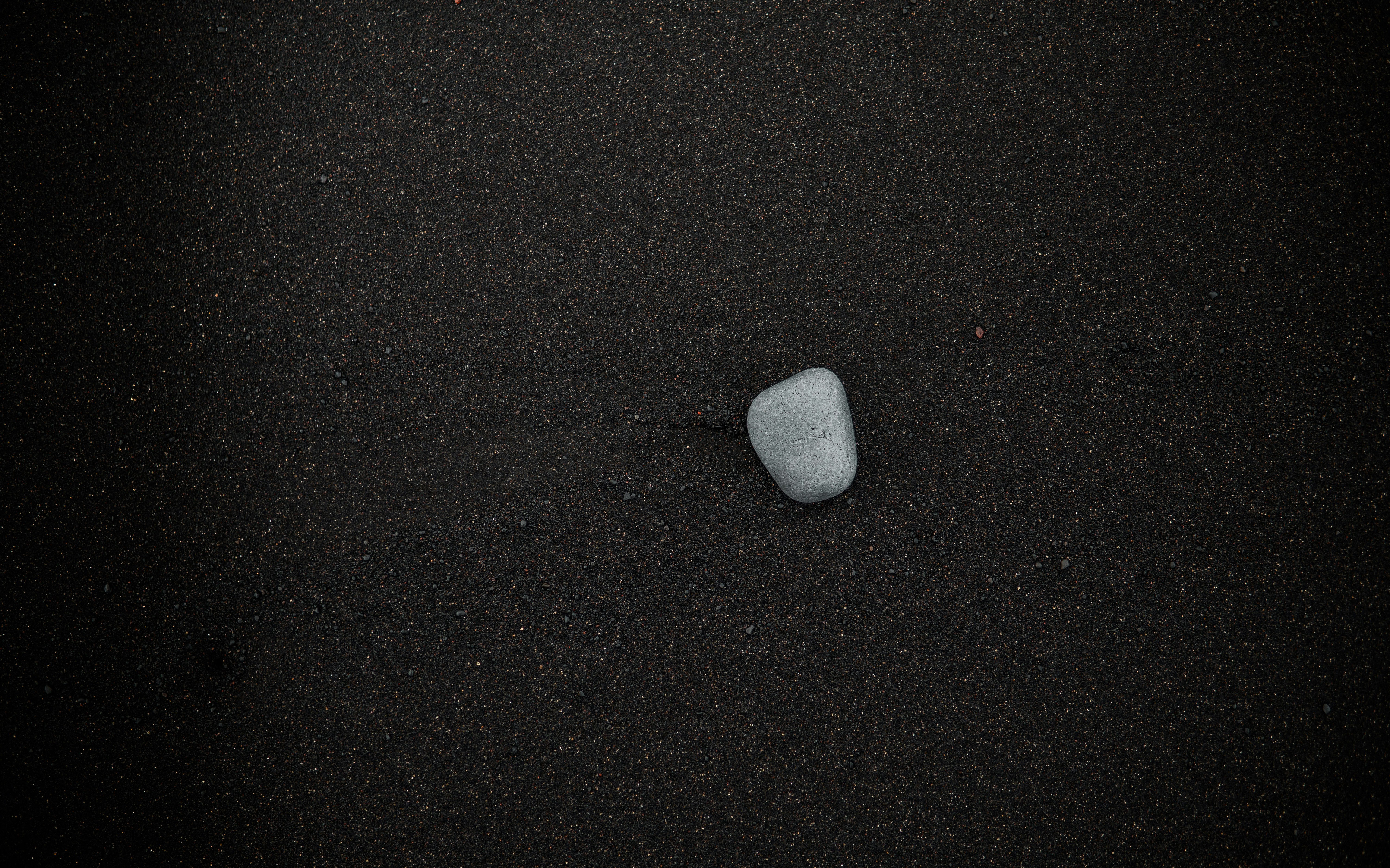 Single stone on black sand