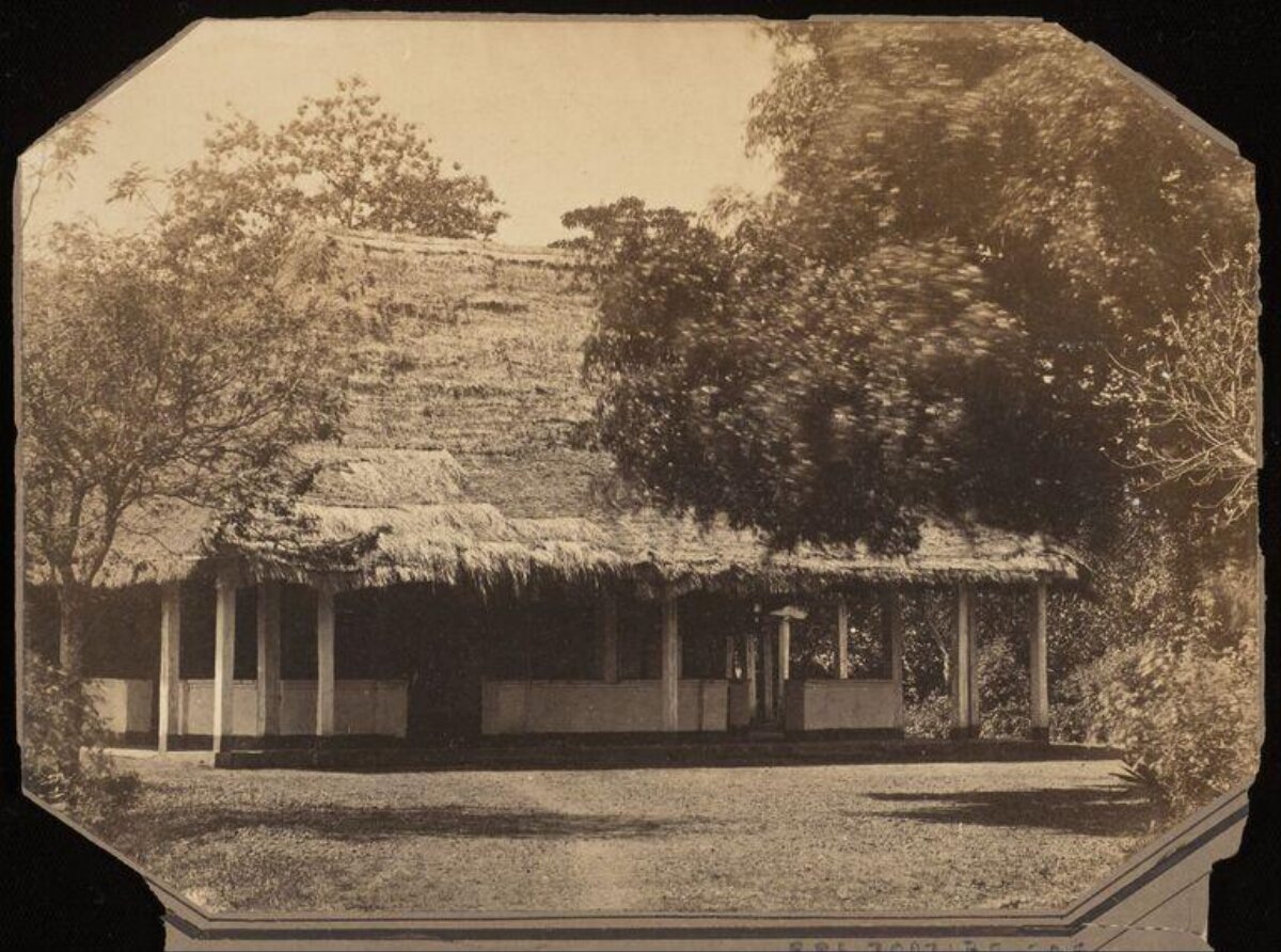 Vintage Thatched Building Before Overgrown Mound