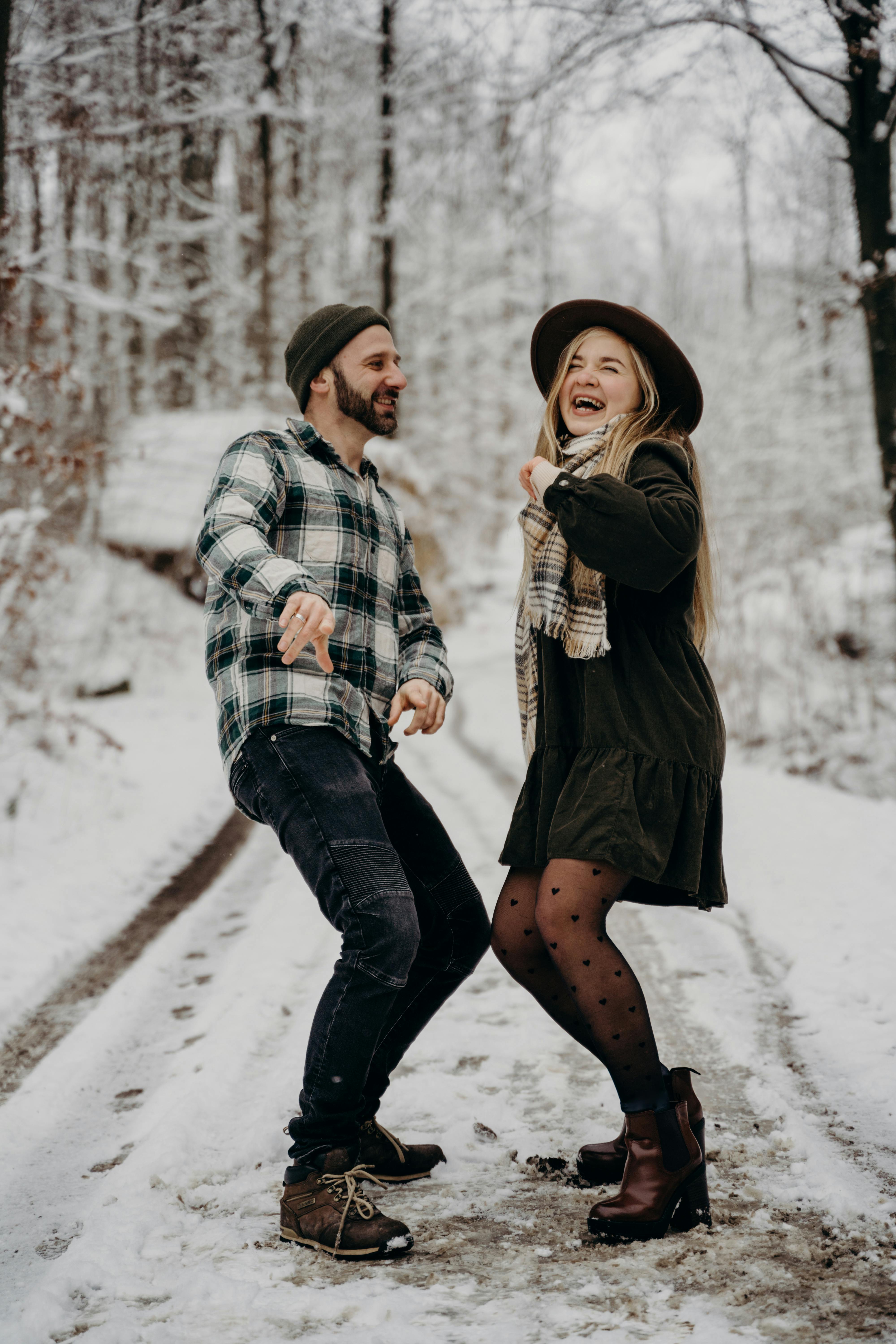 Couple Laughing on Snowy Forest Road