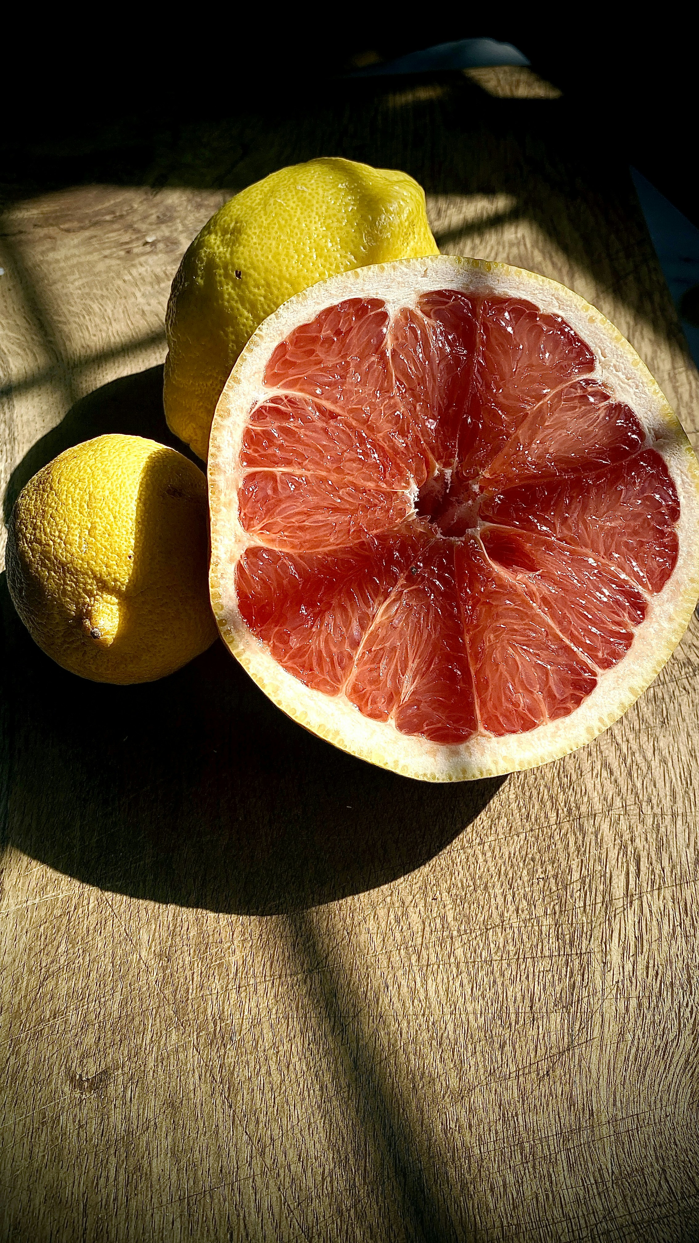 Halved Red Grapefruit and Two Lemons
