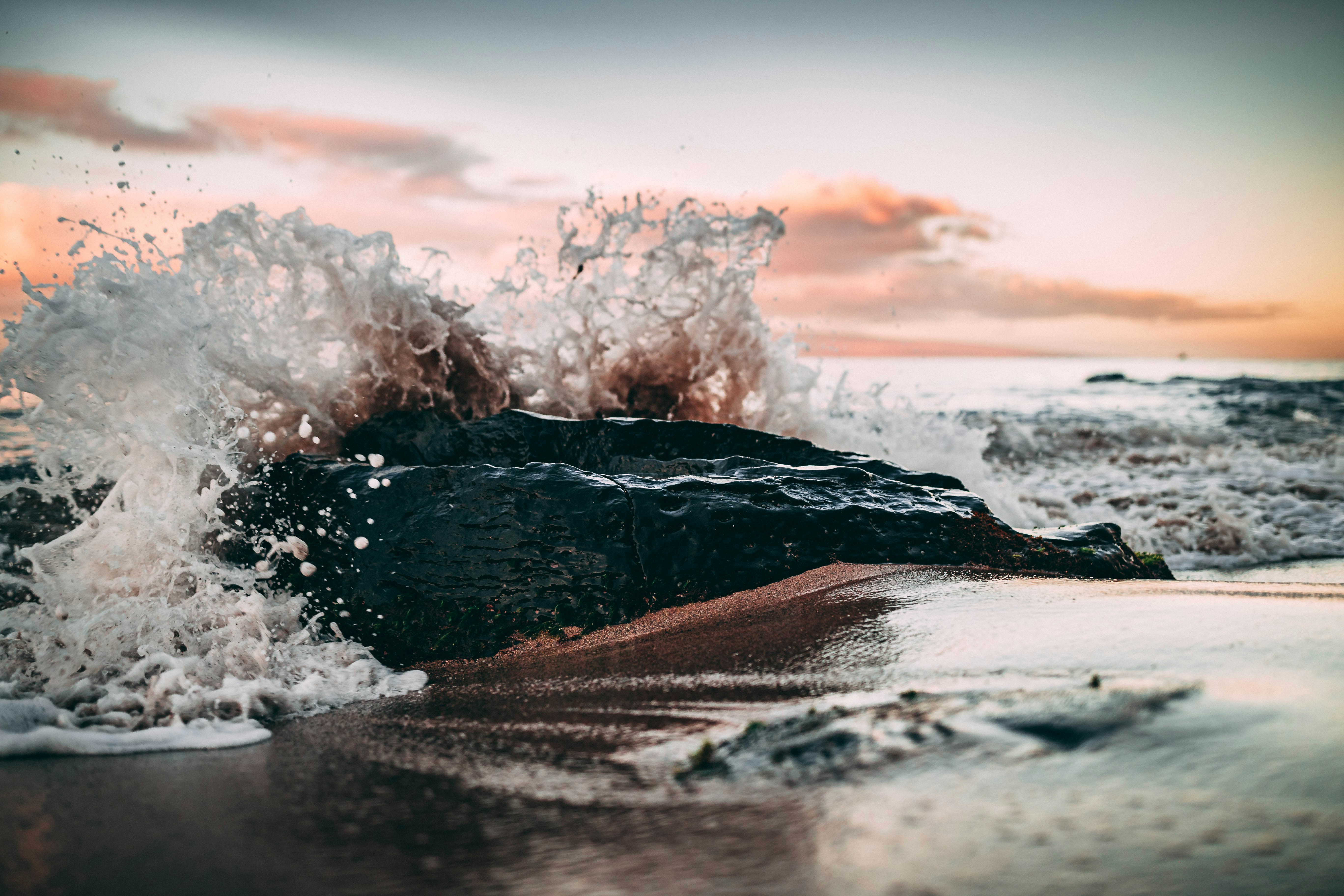 Wave Crashing on Coastal Rock at Sunset