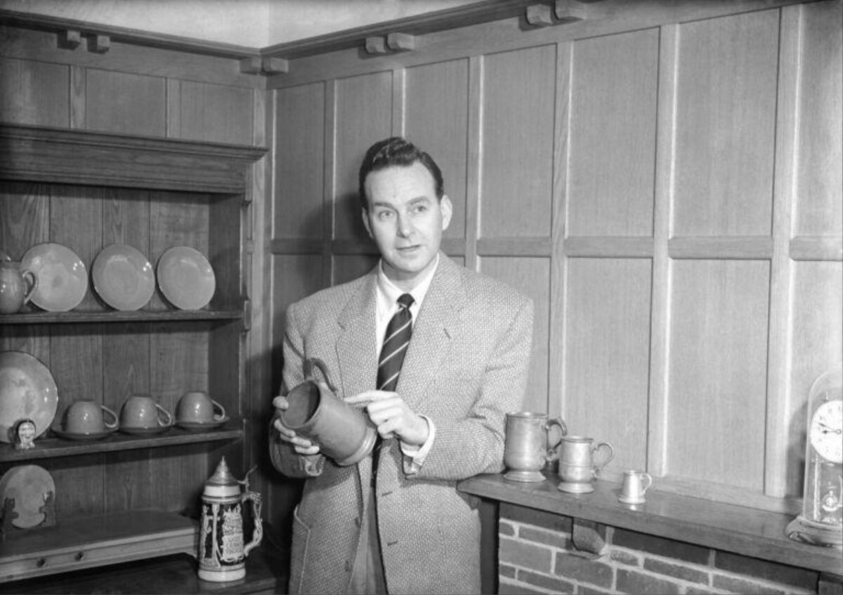 Man Displaying Vintage Drinking Mug