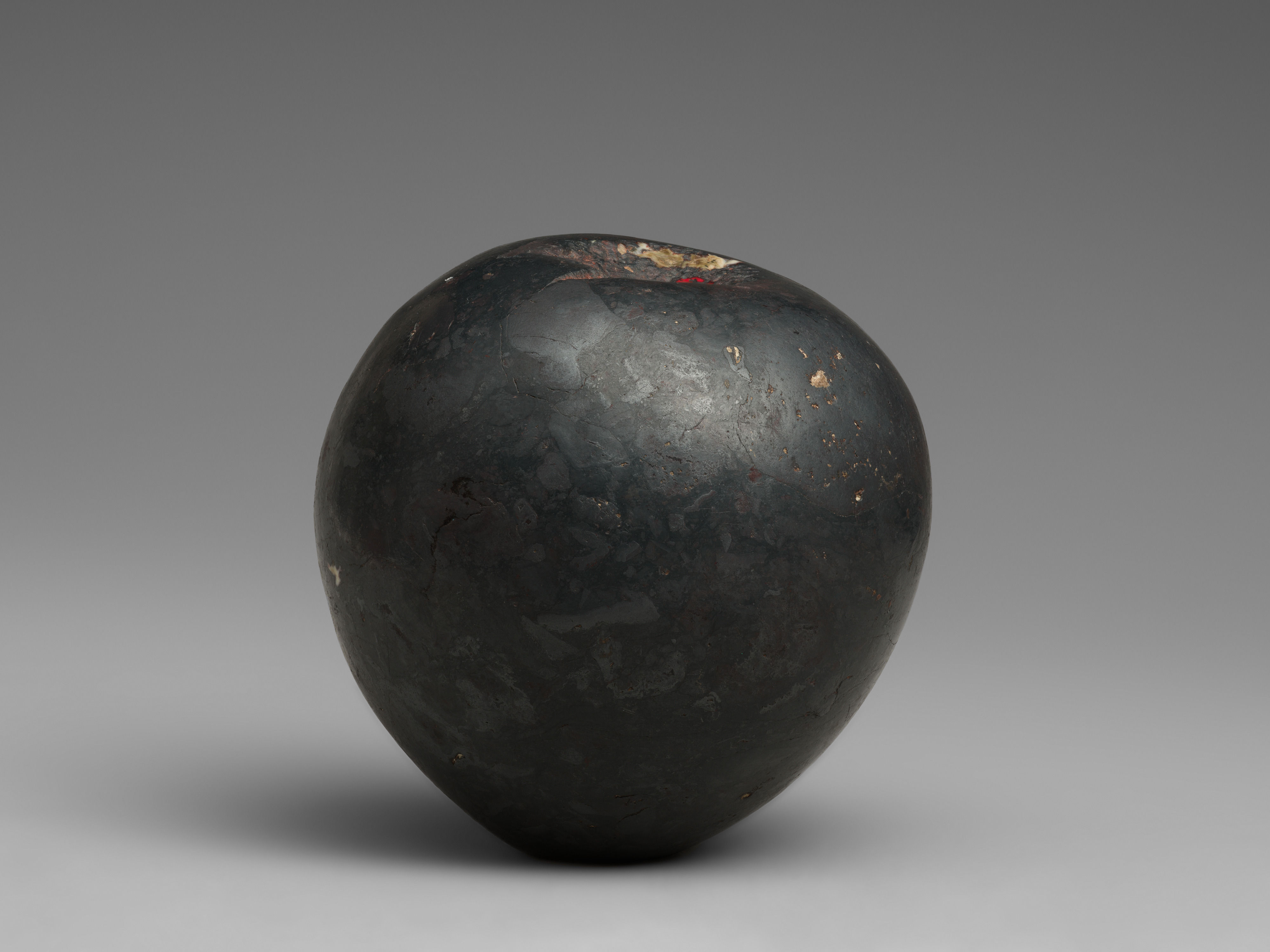 Aged Black Rounded Antique Artifact