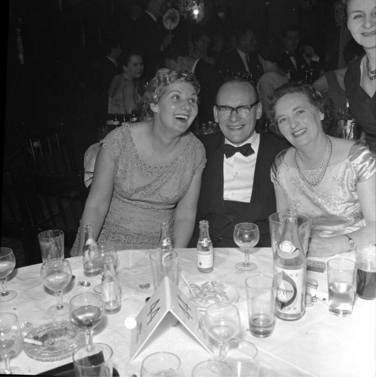 Smiling Guests at Formal Dinner Banquet