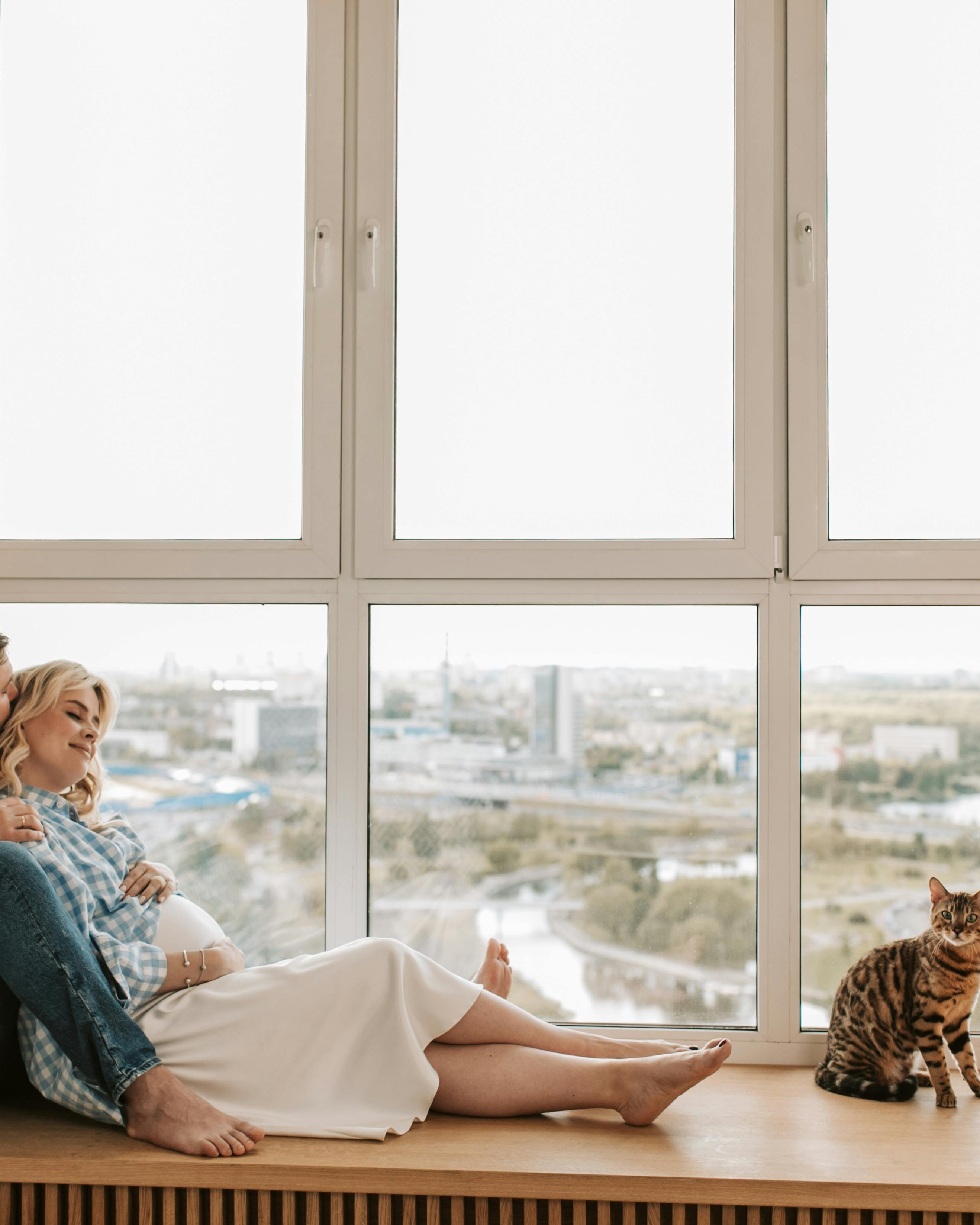 Pregnant Couple and Cat by Window