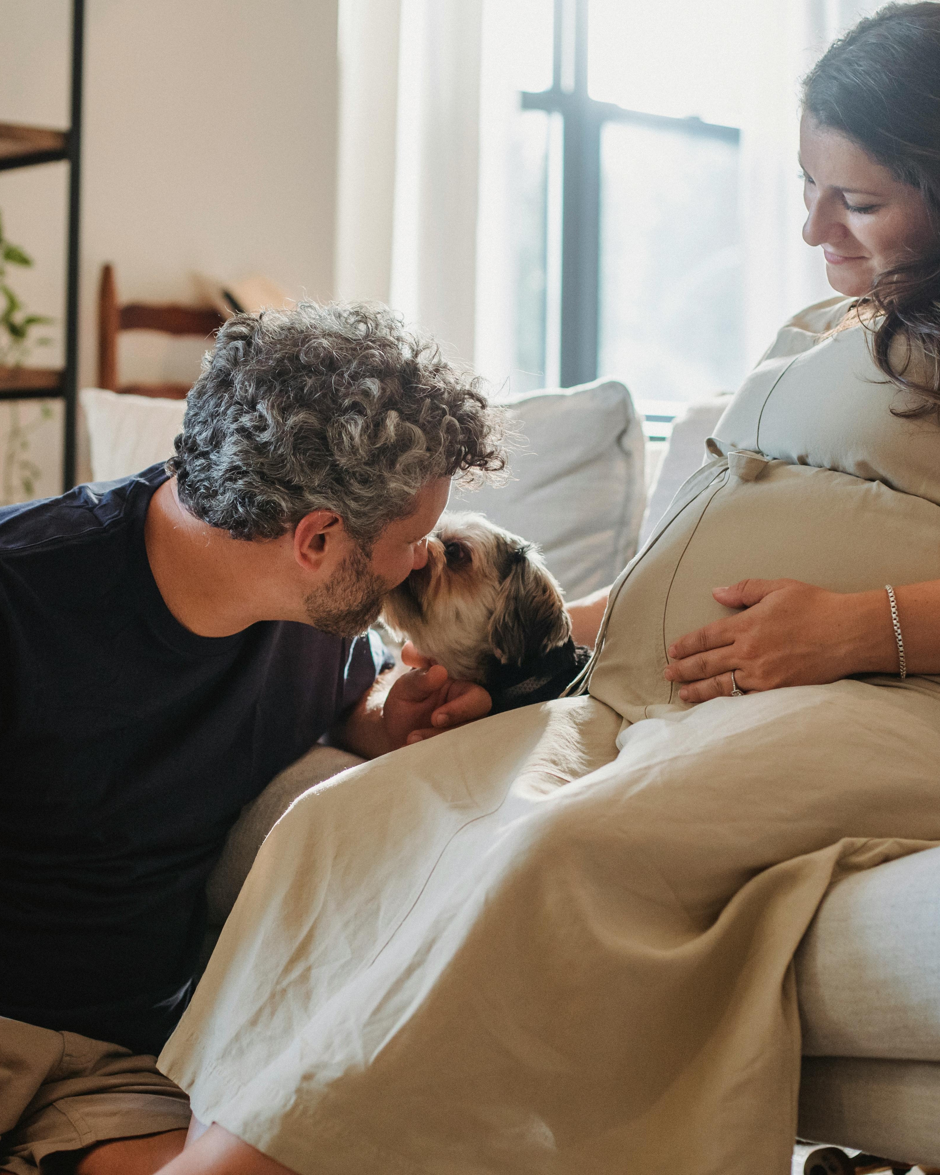 Expecting Couple With Pet Dog At Home