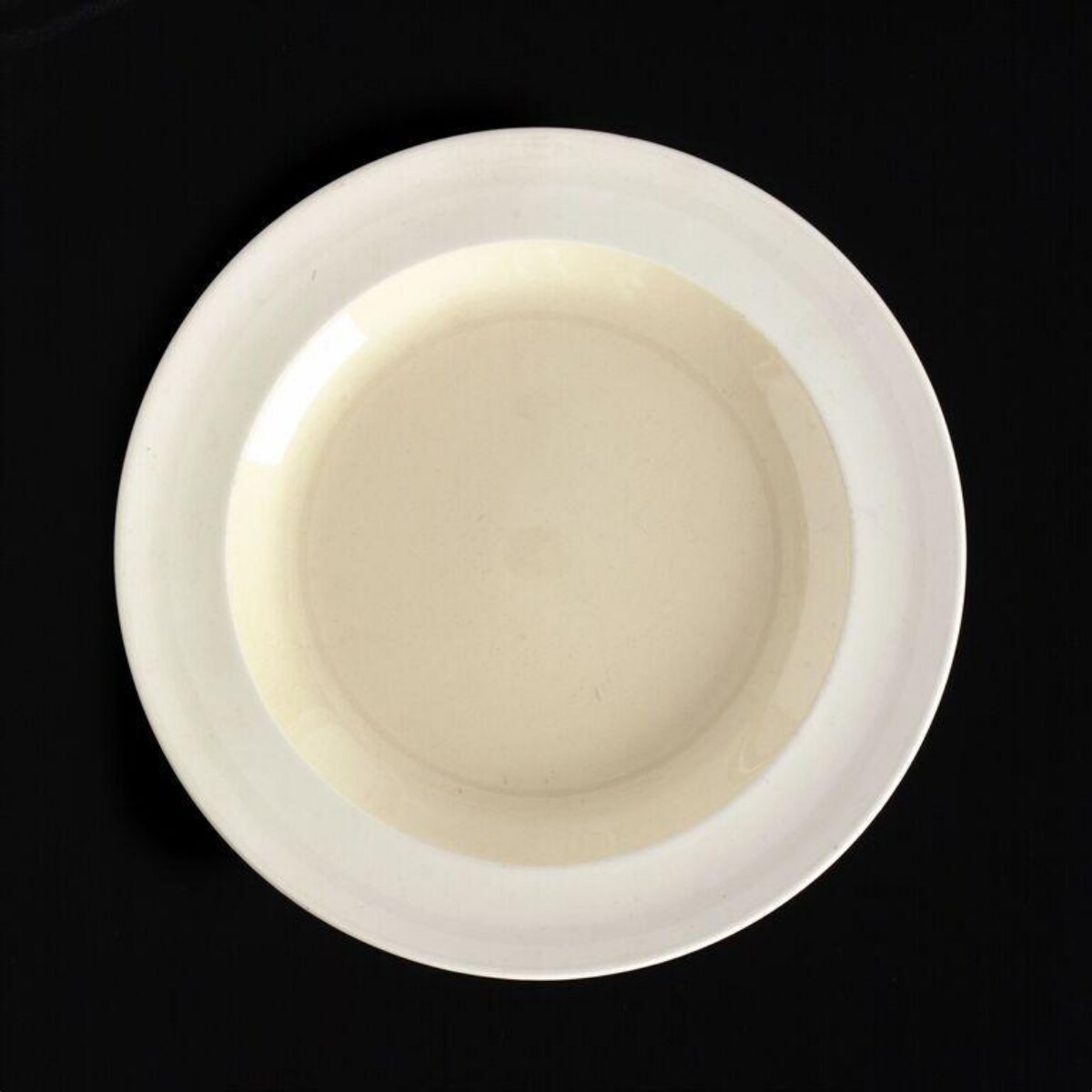 Empty White Plate on Black Background