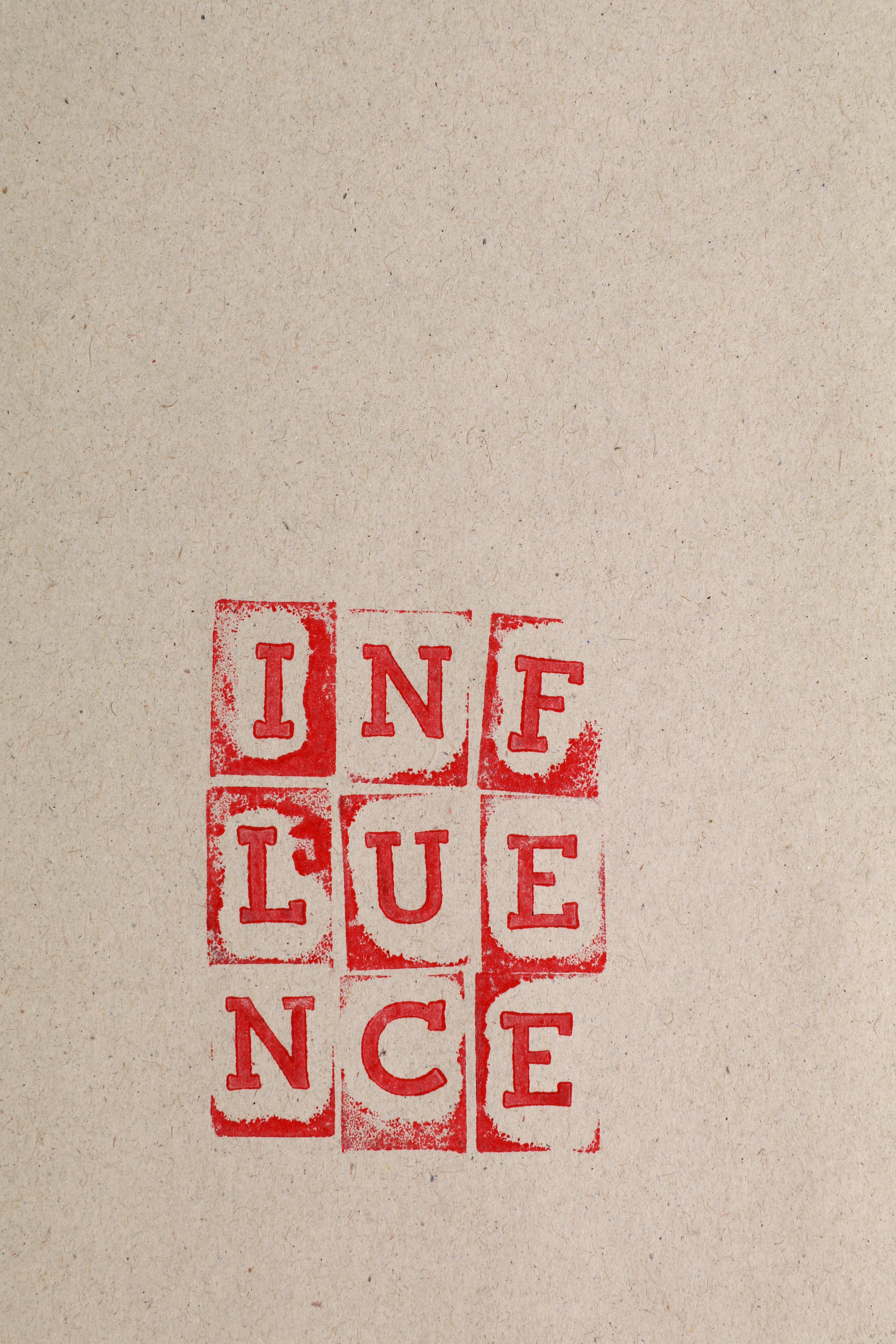 Red Stamped INFLUENCE on Kraft Paper