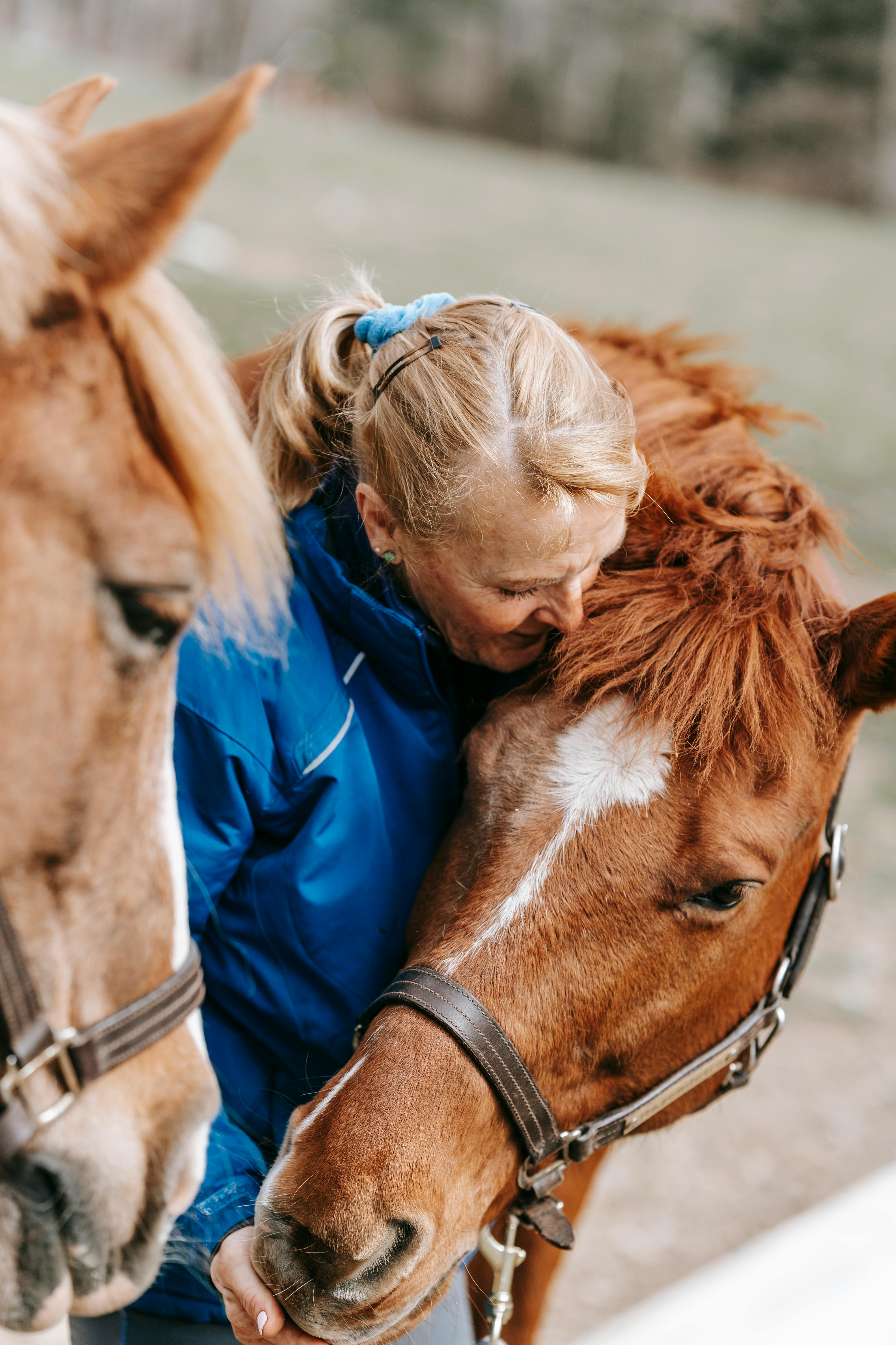 Woman Affectionately Hugging Her Horse