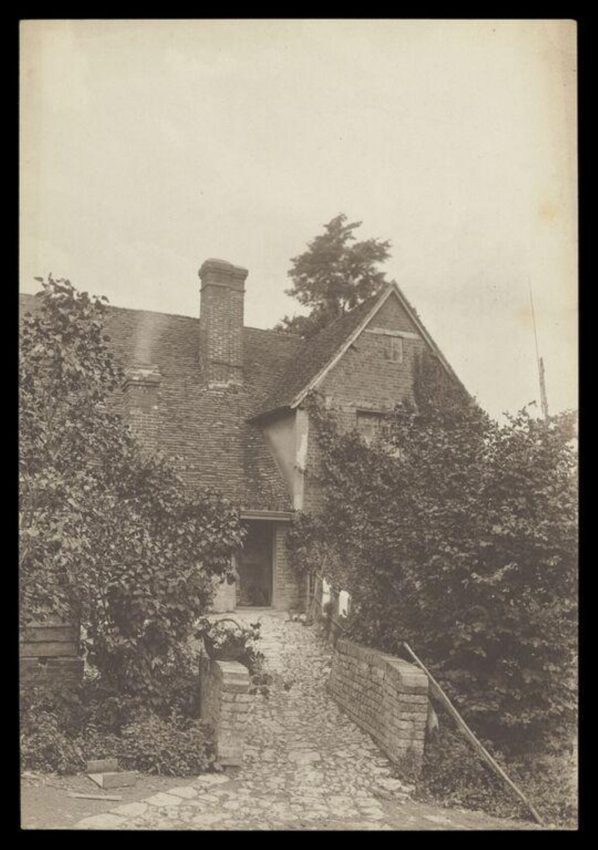 Old Brick Cottage Over Cobblestone Bridge