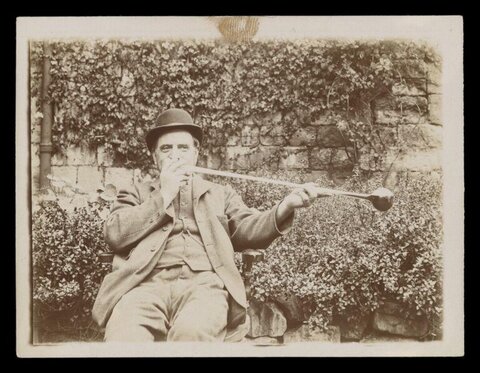 Man With Extra Long Smoking Pipe