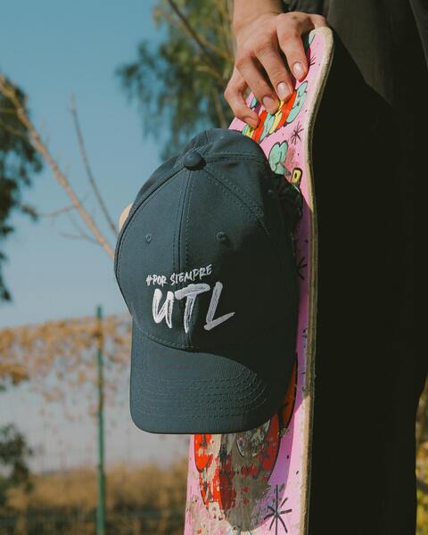 Branded Cap on Painted Skateboard