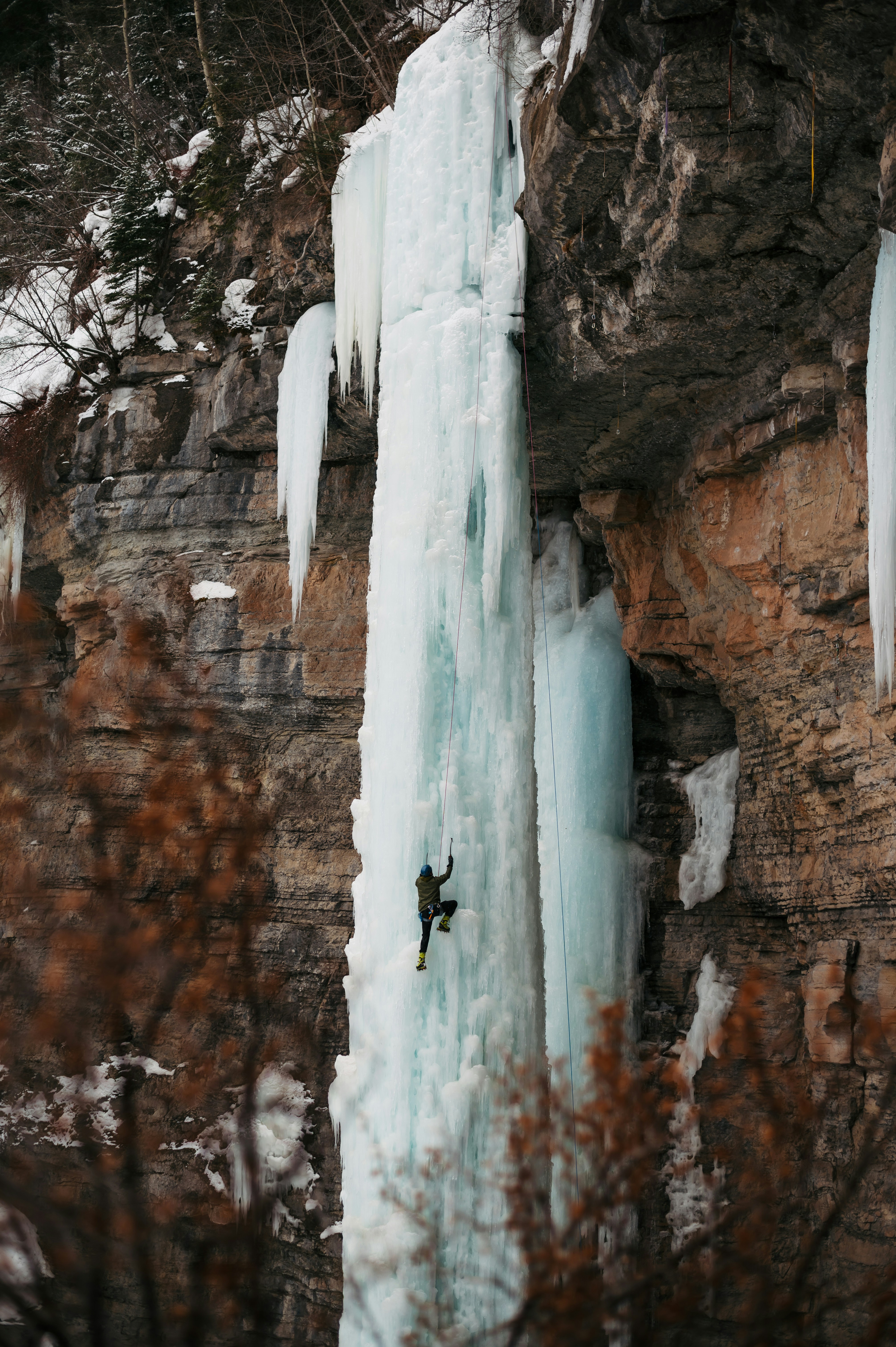 Ice Climber Climbing Frozen Waterfall