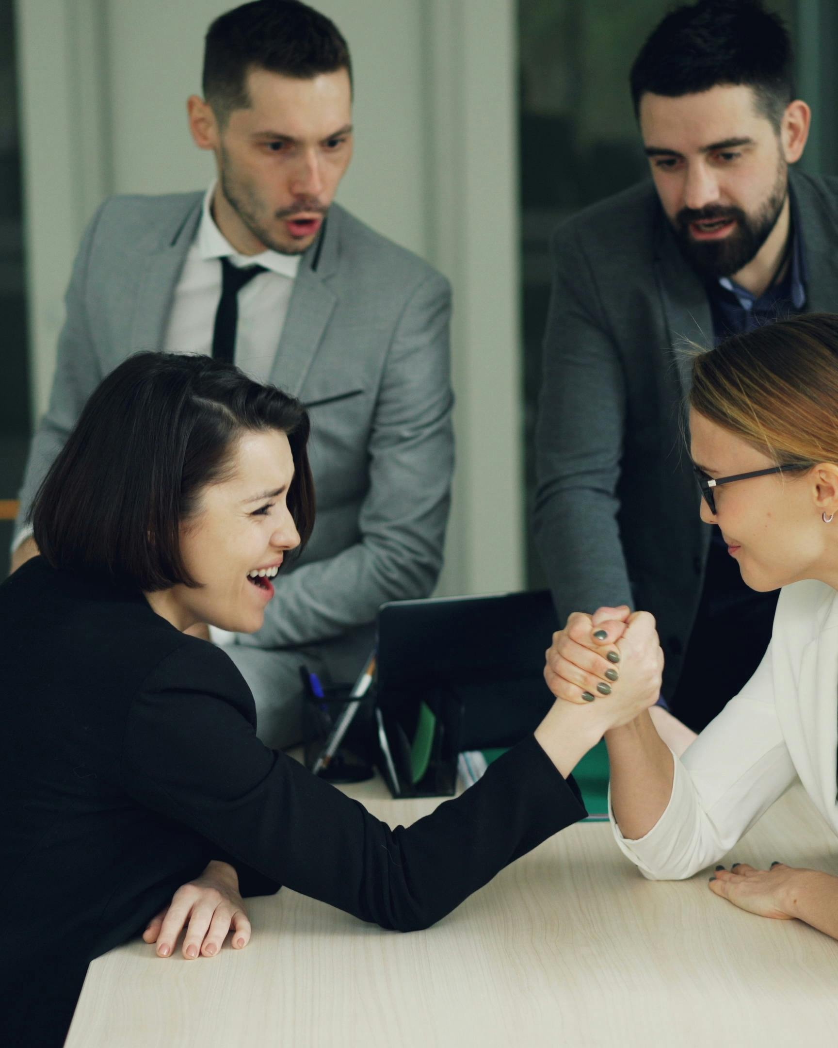 Two Businesswomen Arm Wrestling in Office