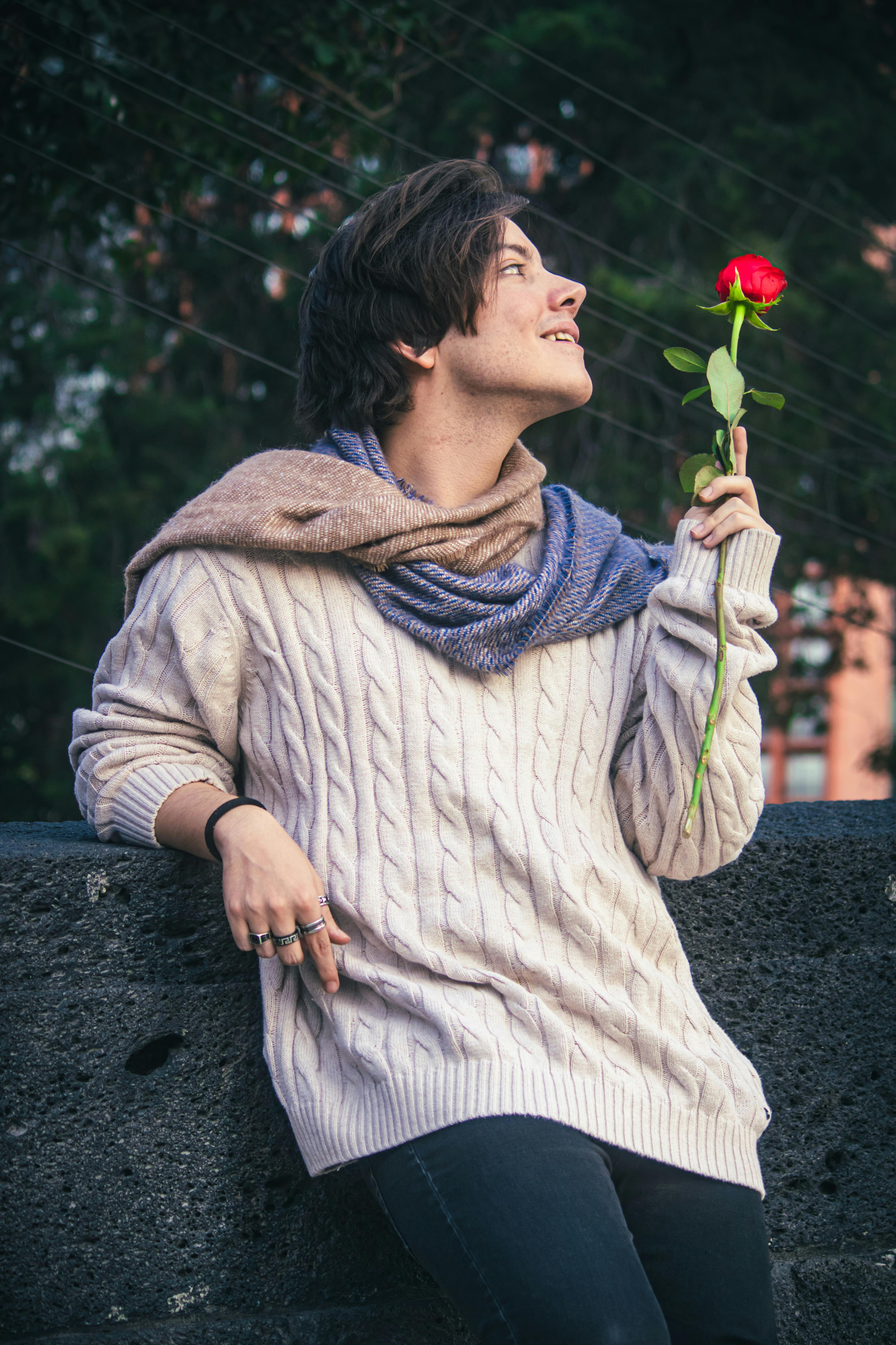 Young Man Holding a Red Rose