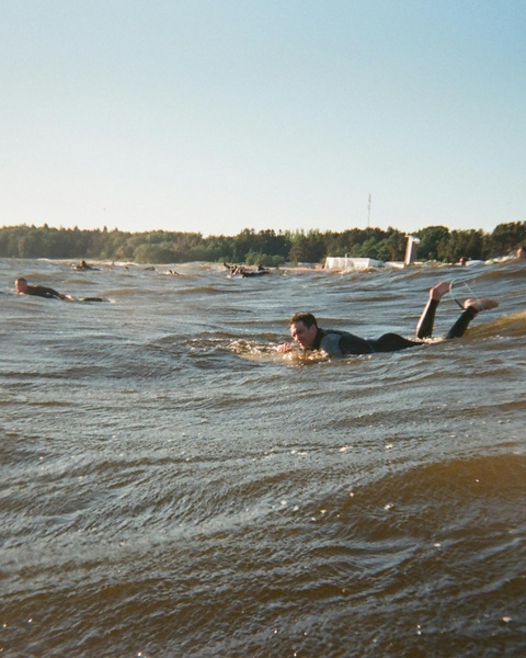 People Paddling on Choppy Lake Water