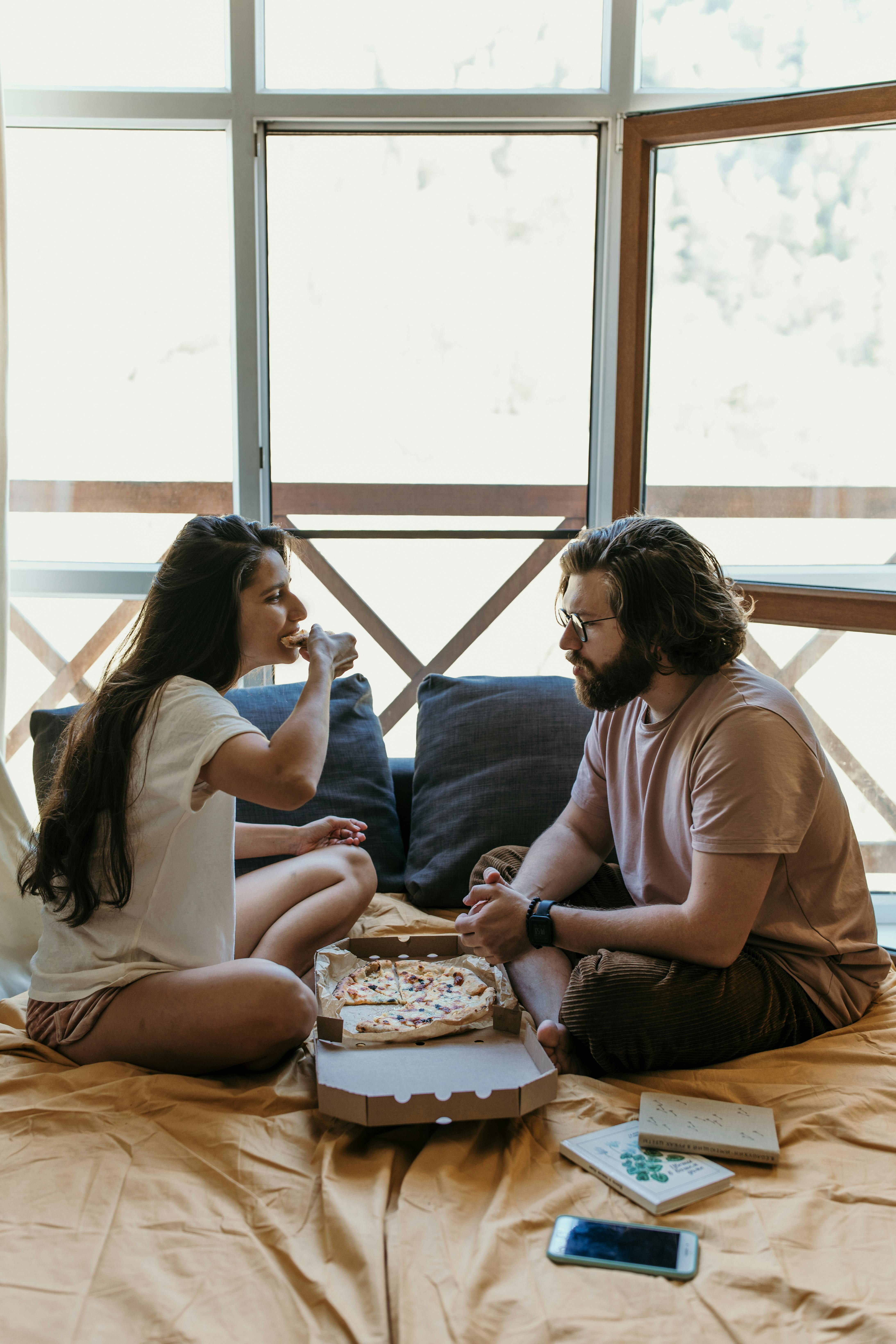 Couple Sharing Pizza At Home