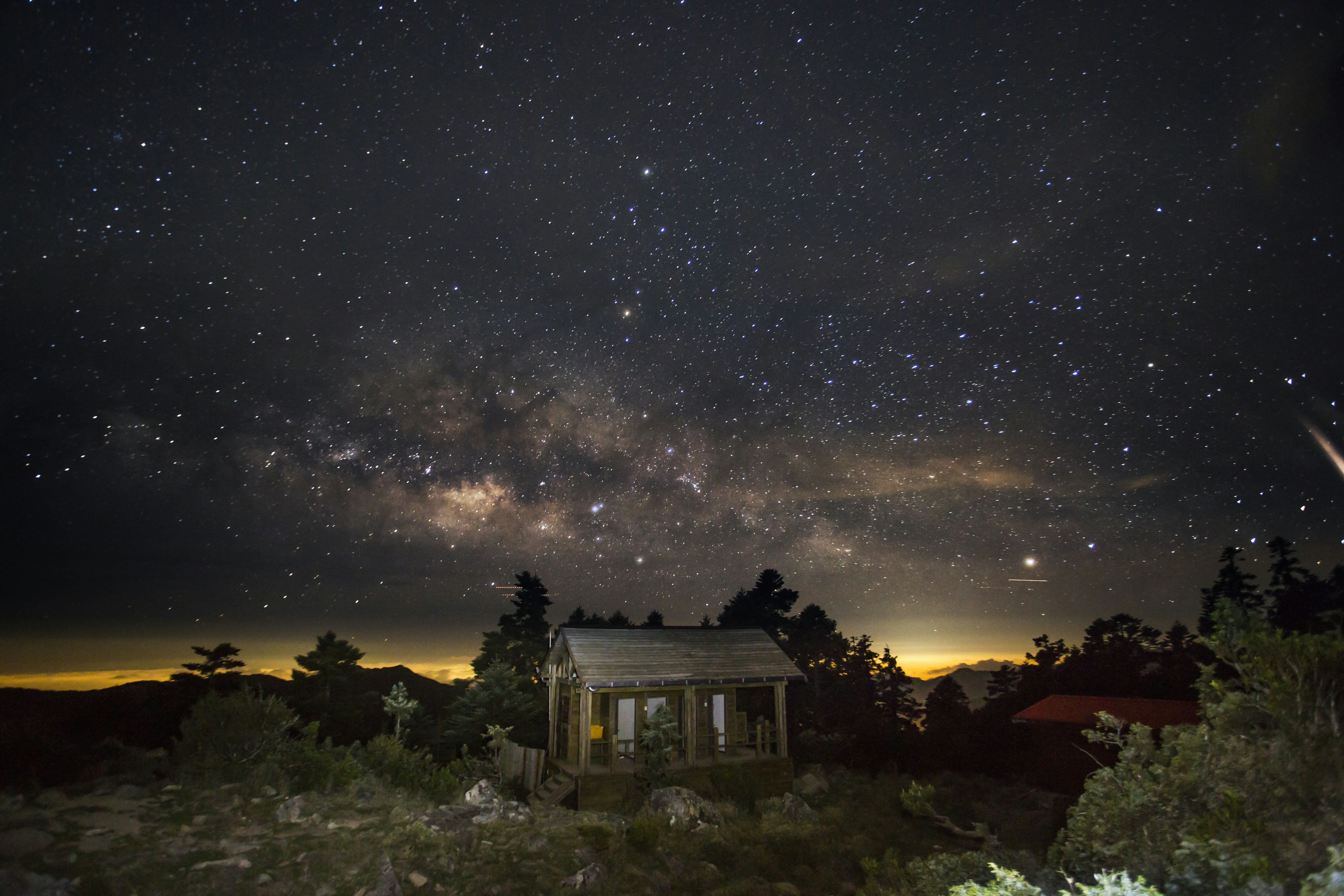 Mountain Cabin Under Starry Night Sky